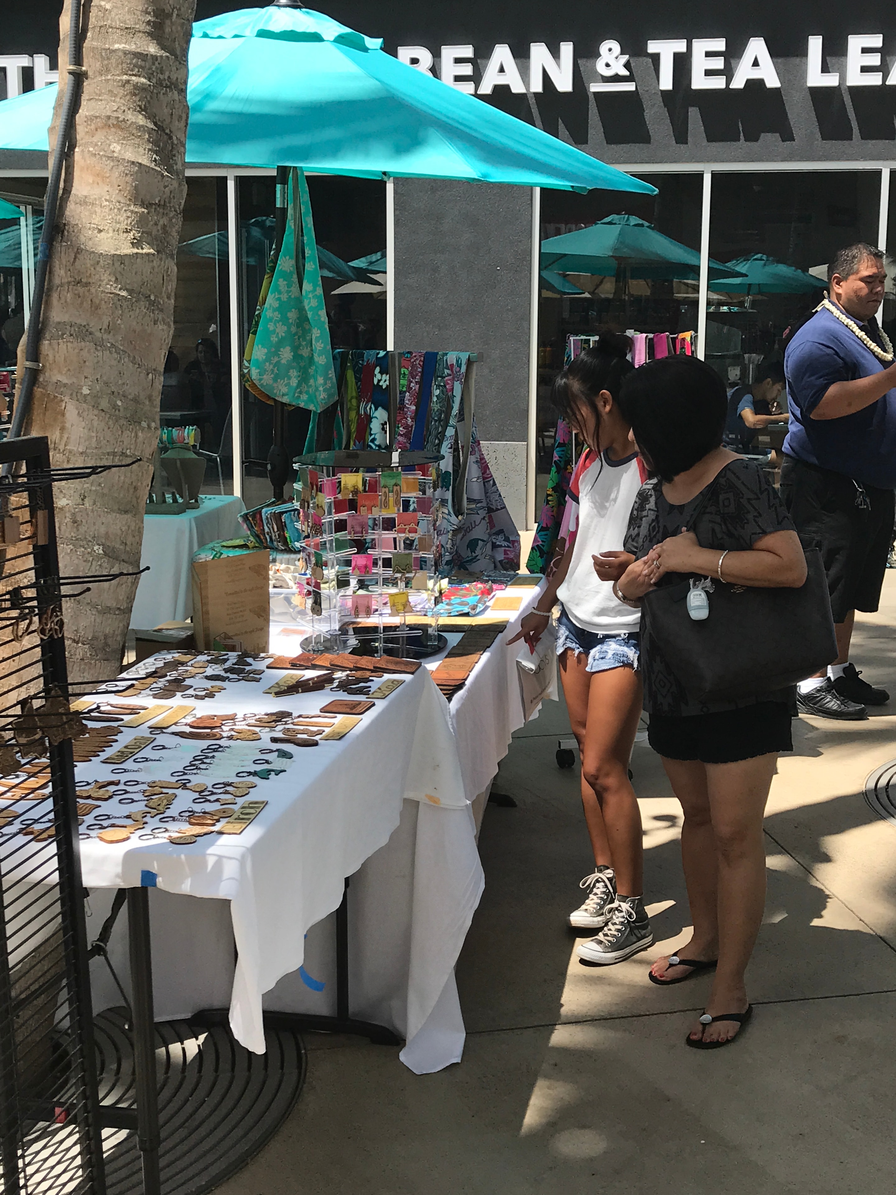 Vendor booth with colorful Hawaiian crafts and jewelry