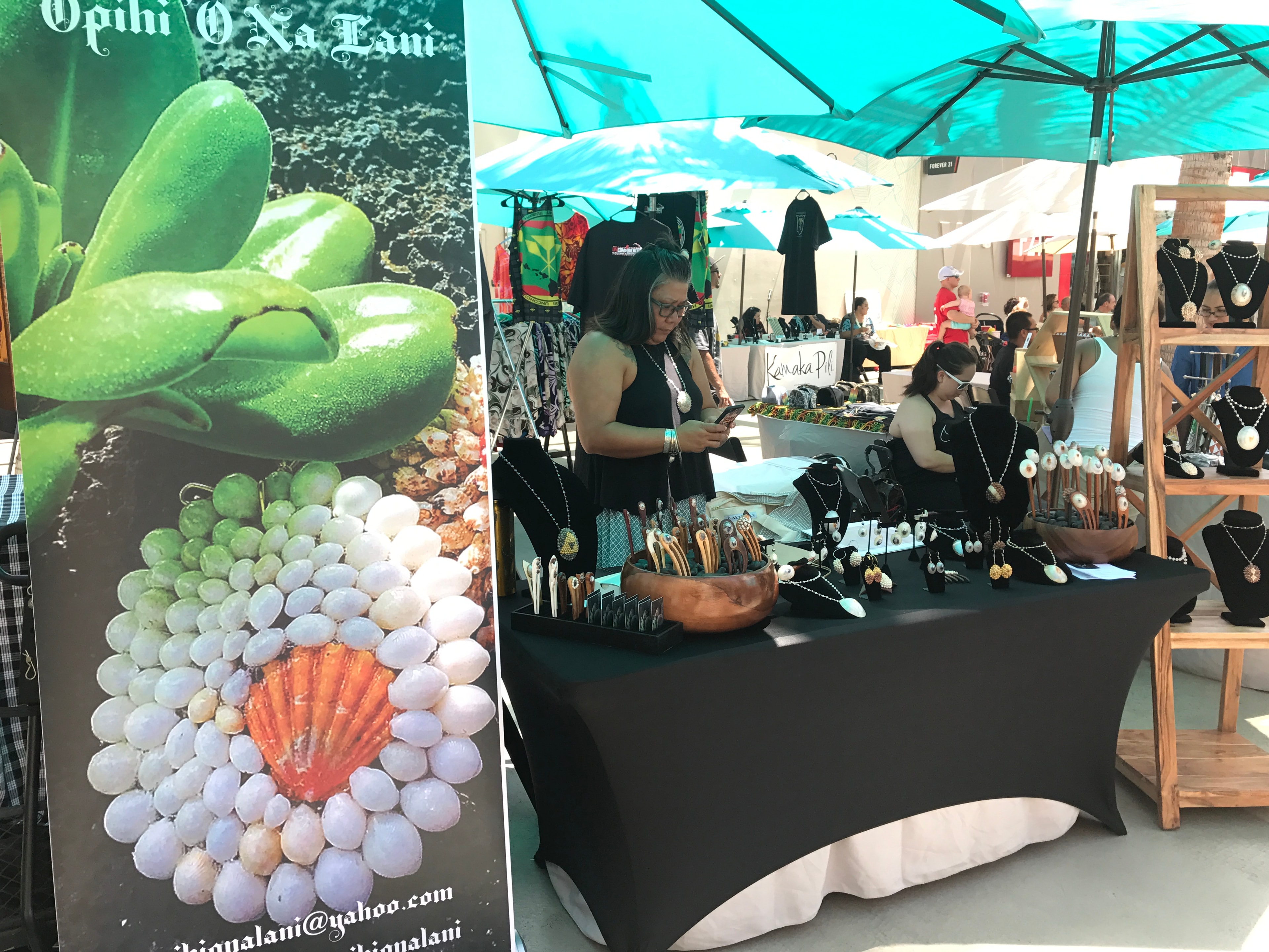 Outdoor market vendor selling handmade jewelry