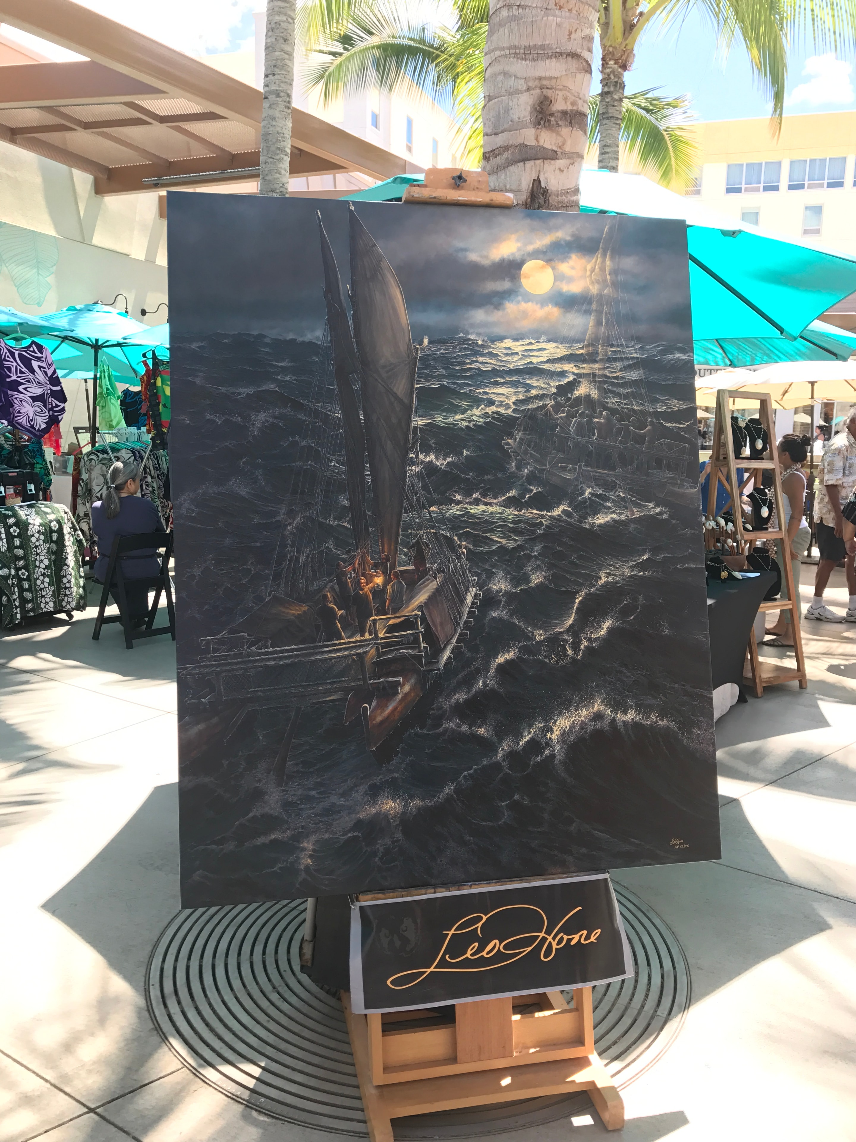 Dramatic sailboat painting displayed at outdoor art booth