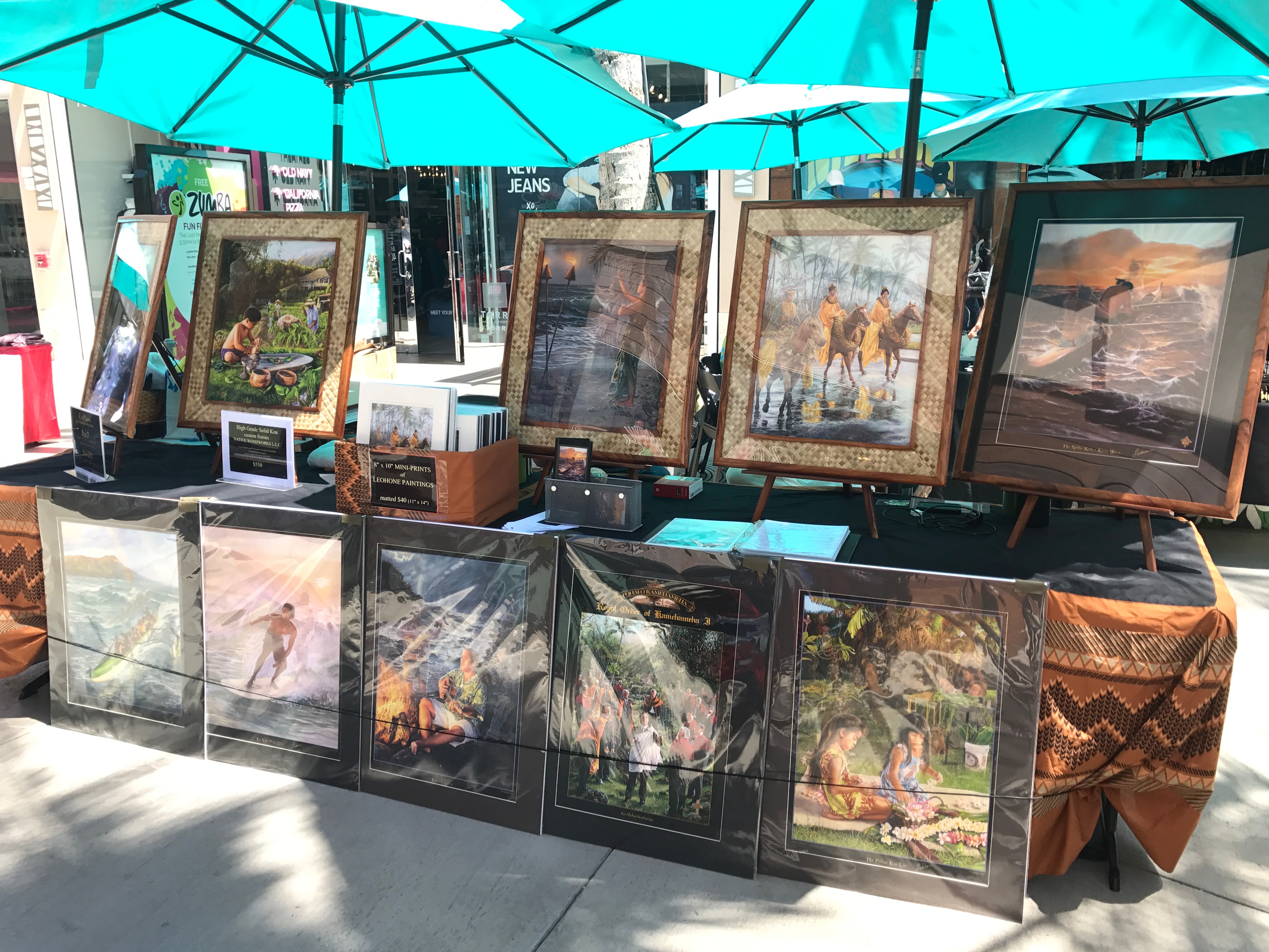 Hawaiian art prints by Leohone displayed under teal umbrellas
