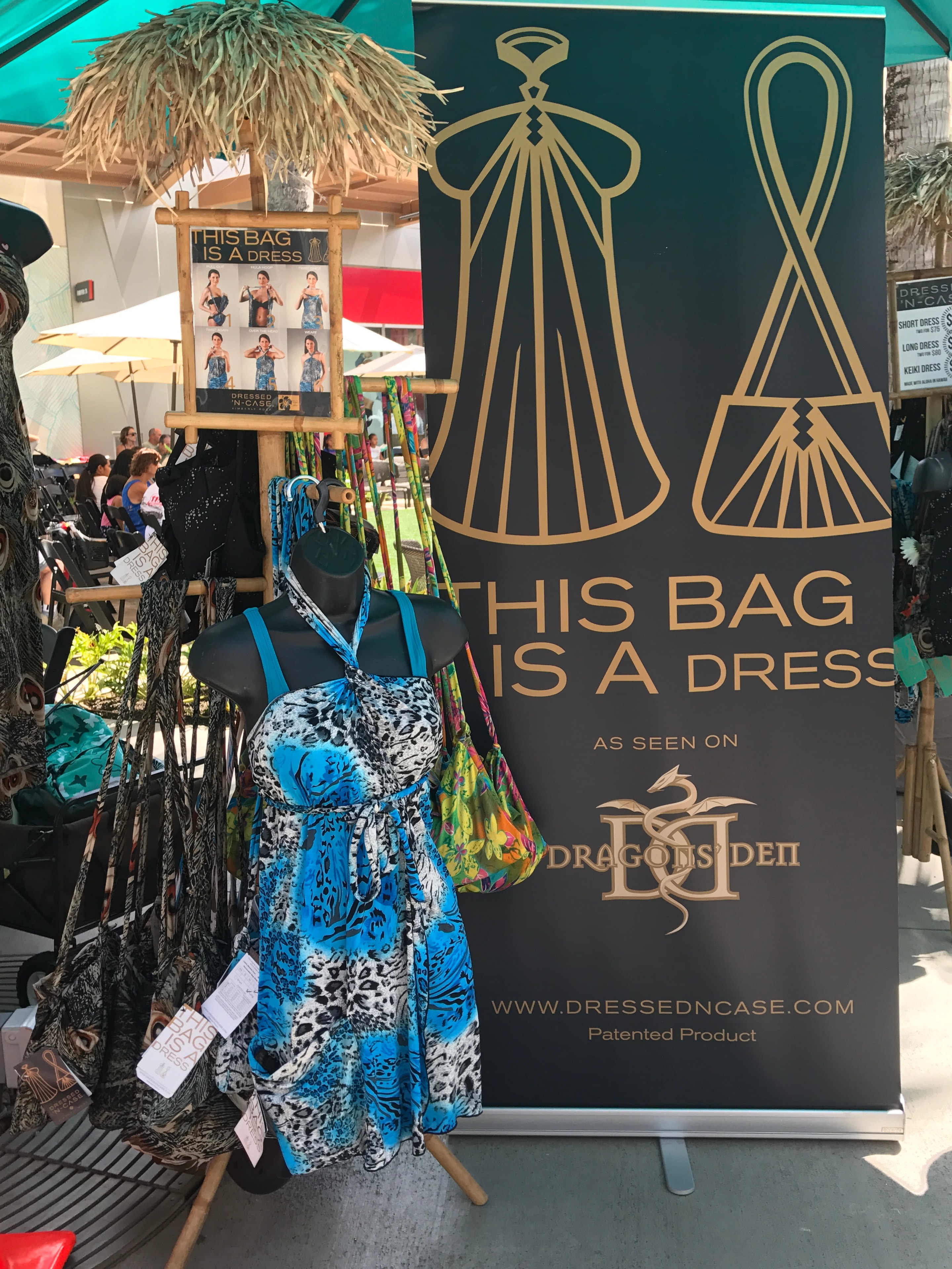 This Bag Is A Dress vendor booth with patterned clothing display