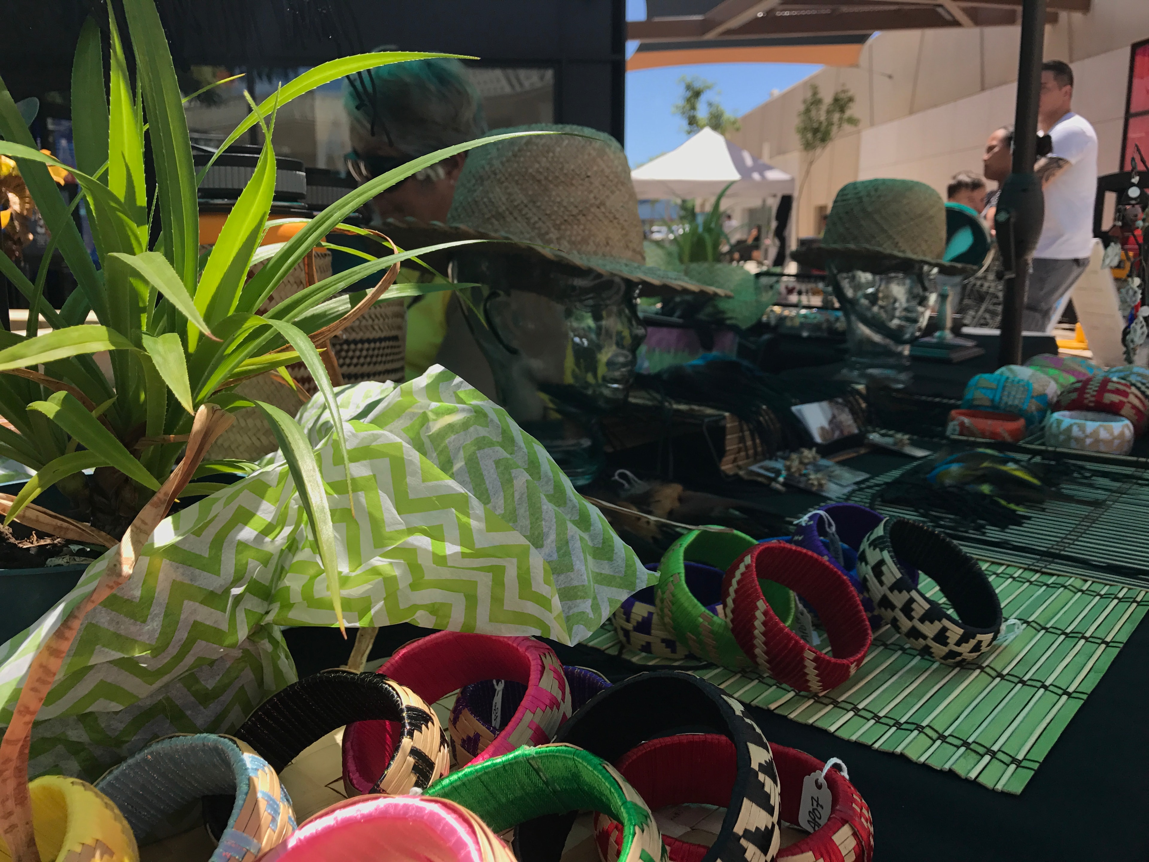 Colorful woven bracelets displayed at outdoor market booth