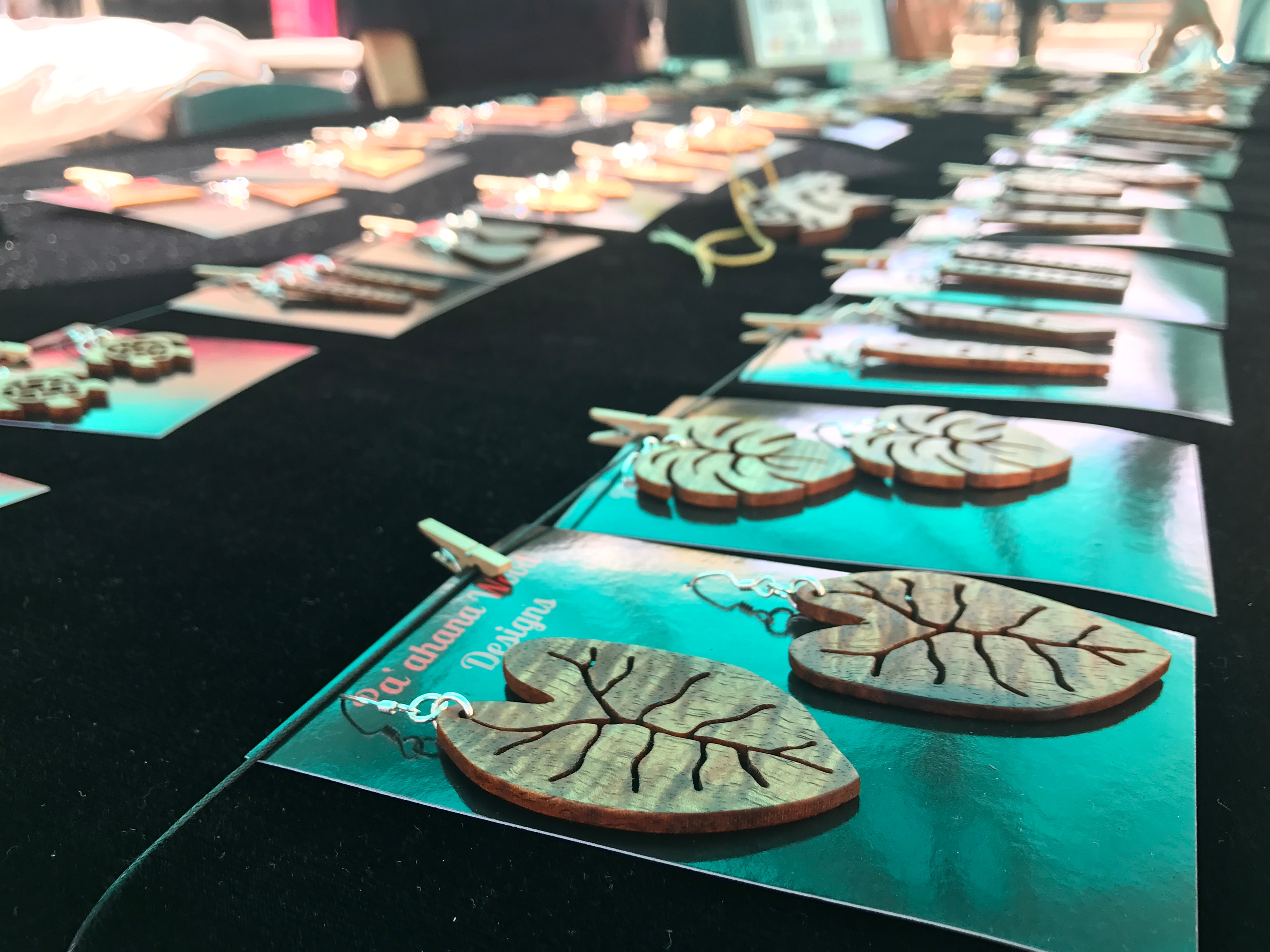 Handcrafted wooden ornaments and accessories displayed on table with turquoise accents
