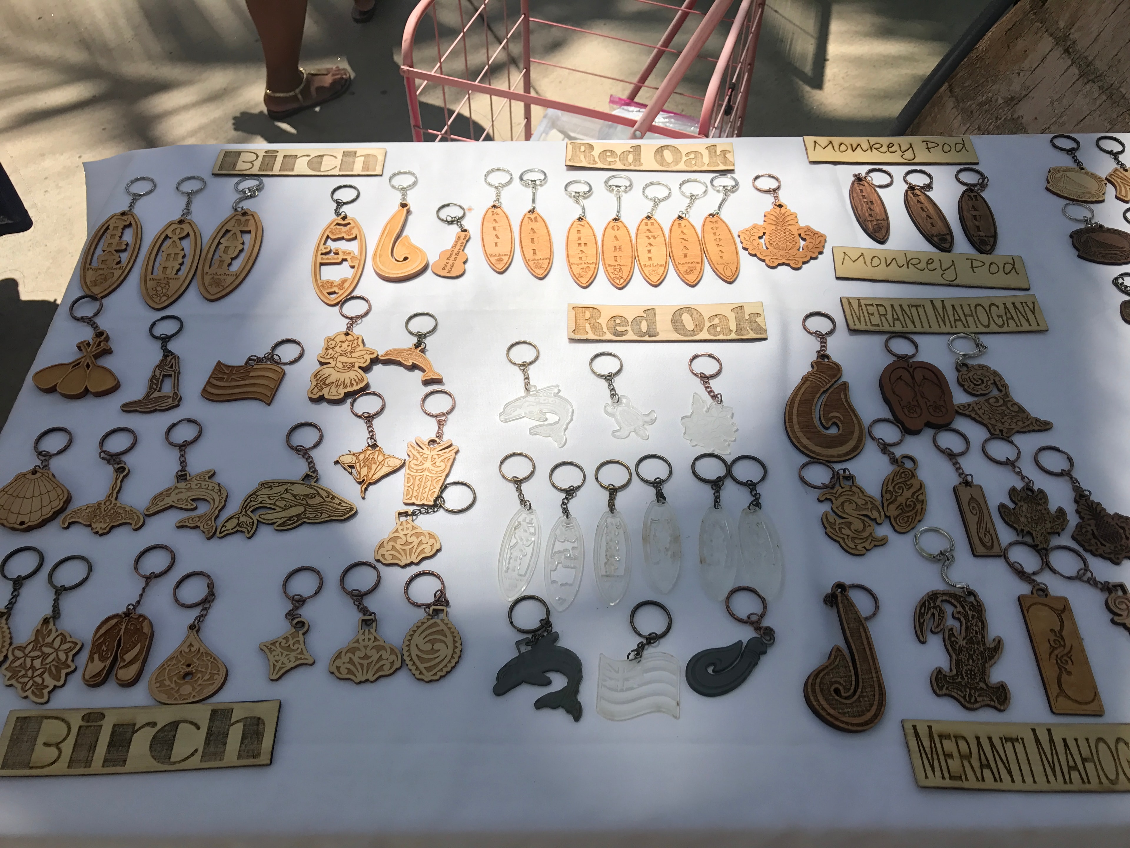Wooden keychains in birch, red oak, monkey pod, and meranti mahogany displayed on white table