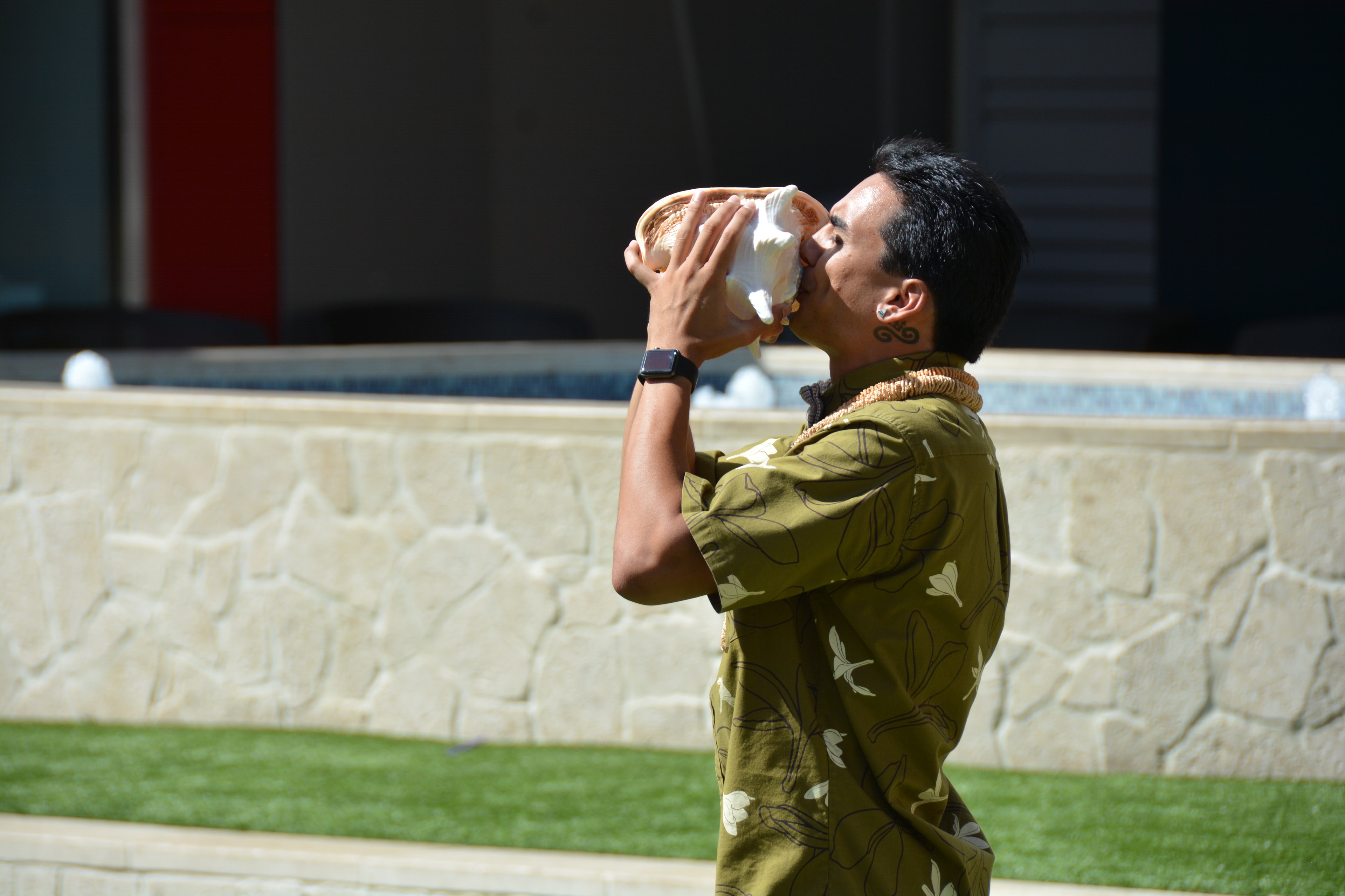 Man eating sandwich outdoors stadium