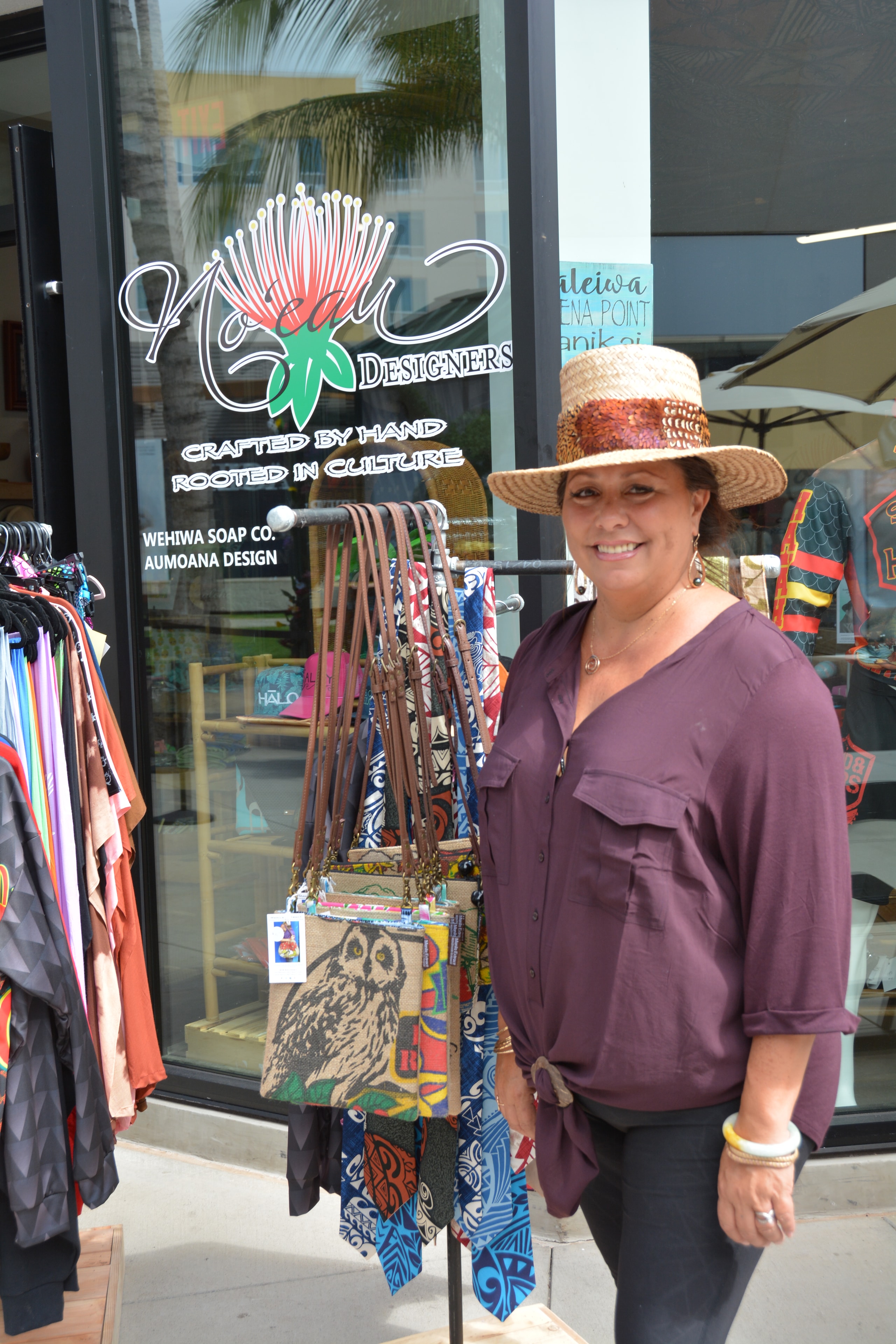 Woman displaying handmade accessories outside boutique