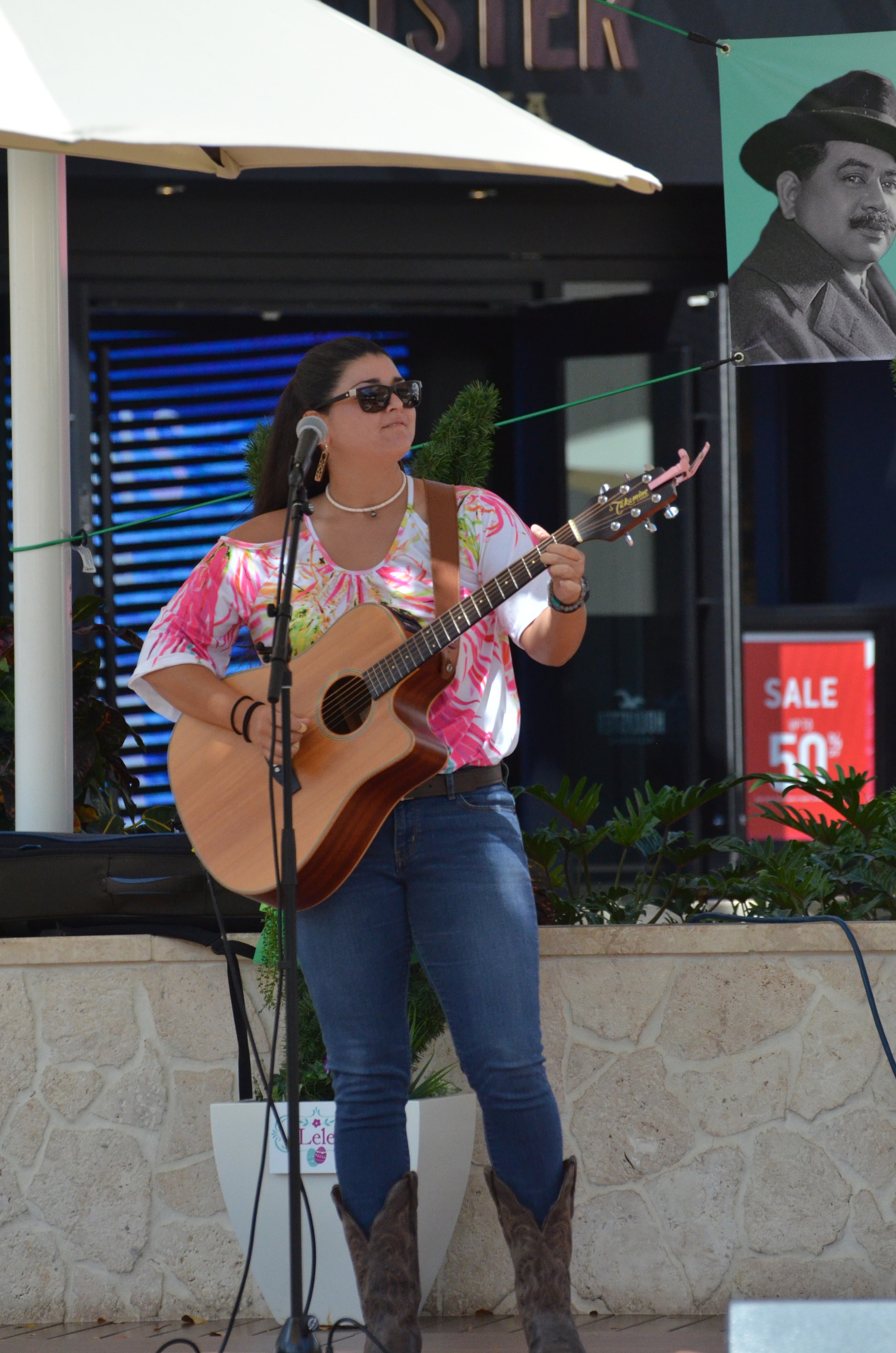 Woman performing acoustic guitar outdoor venue