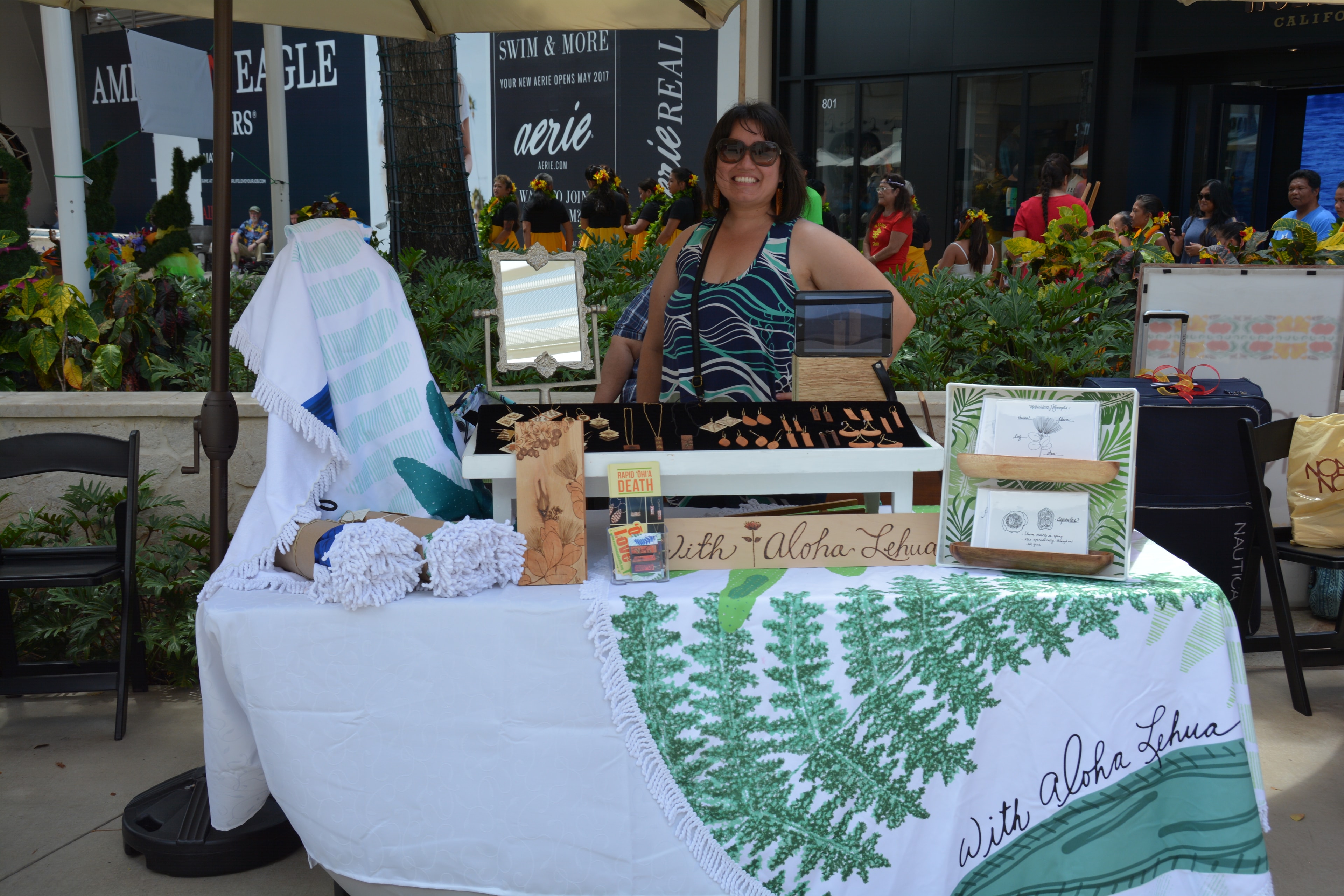 Woman at Aloha Lehua market vendor booth