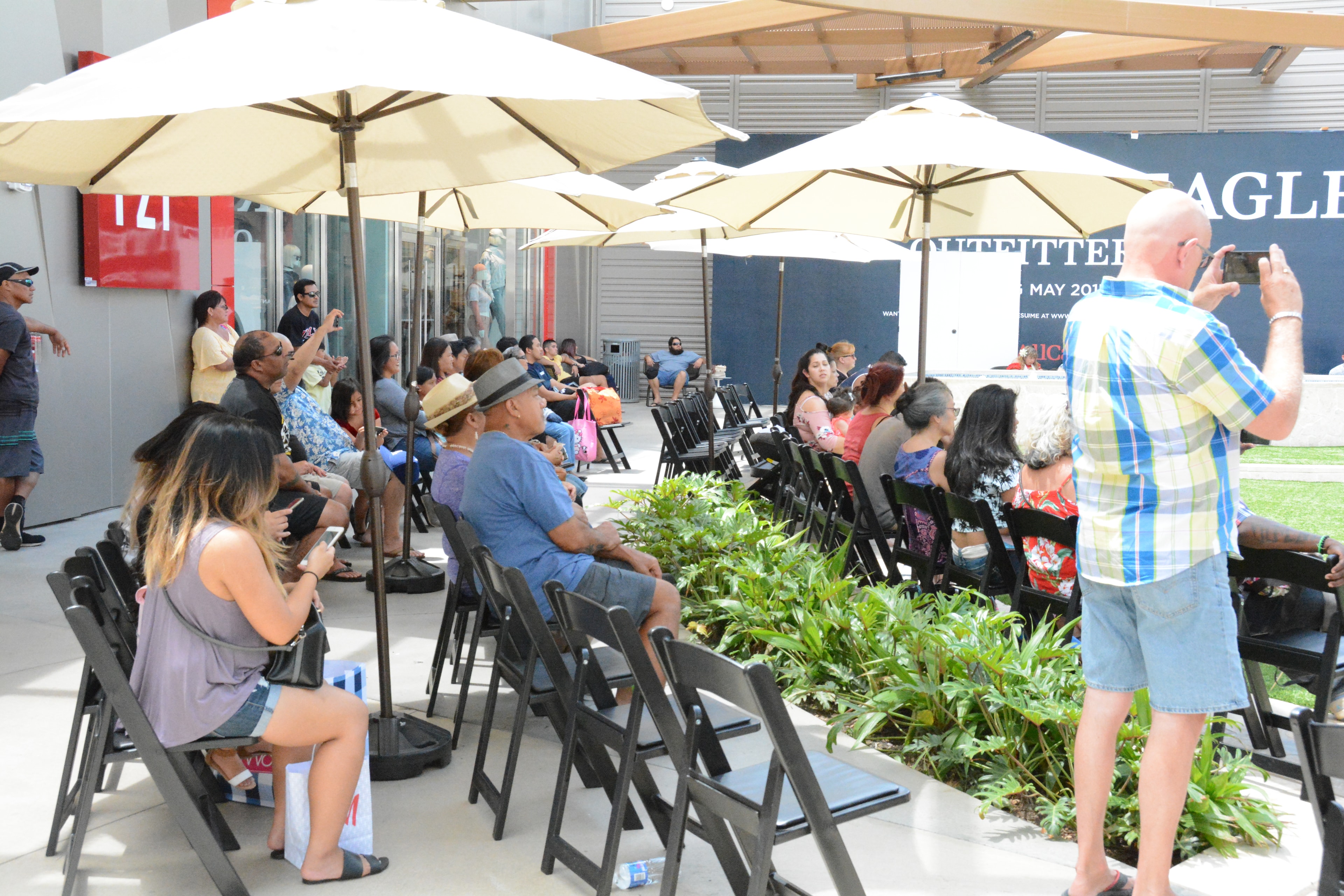 Outdoor event gathering under umbrellas
