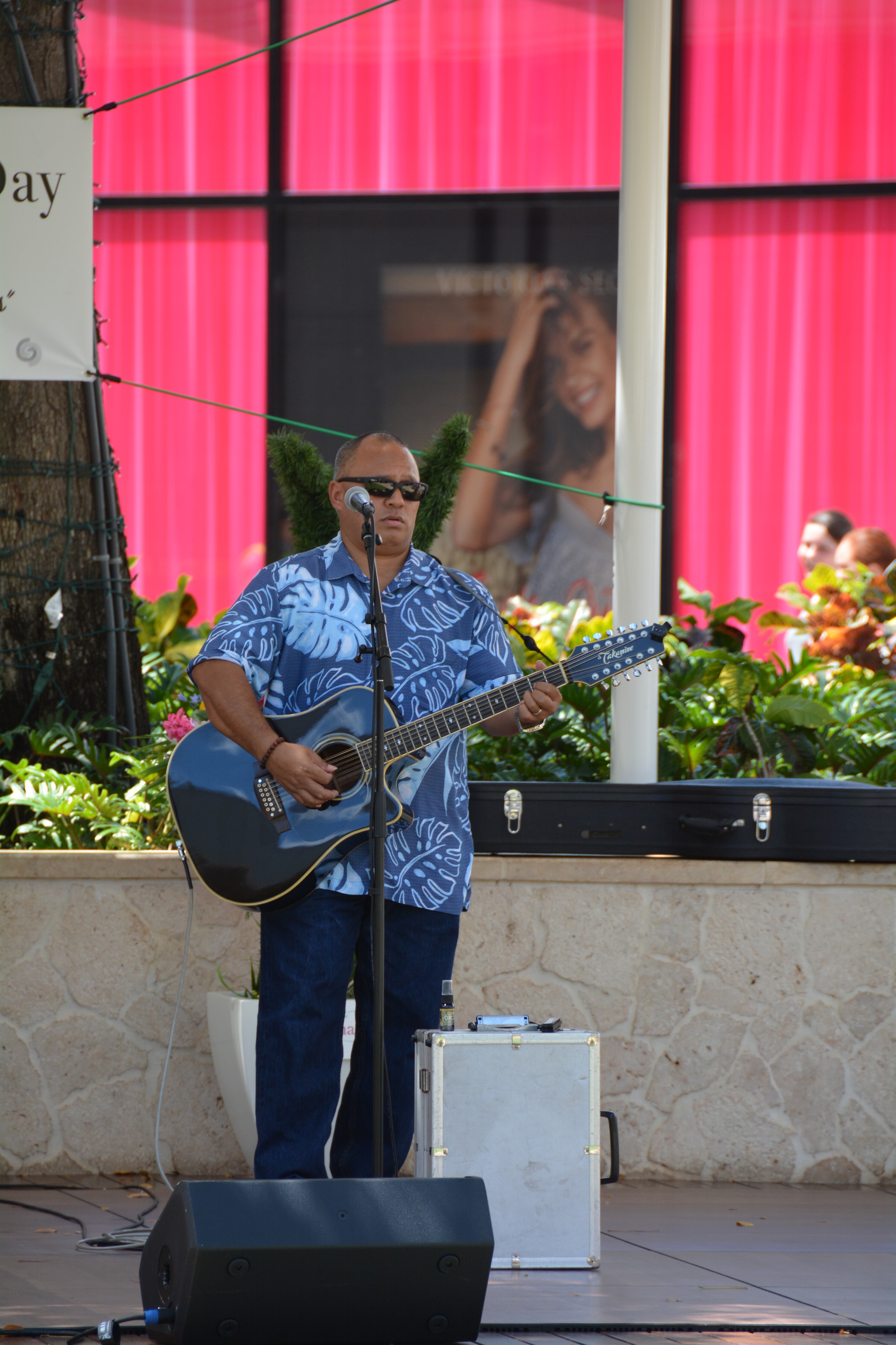 Musician performing acoustic guitar outdoor stage