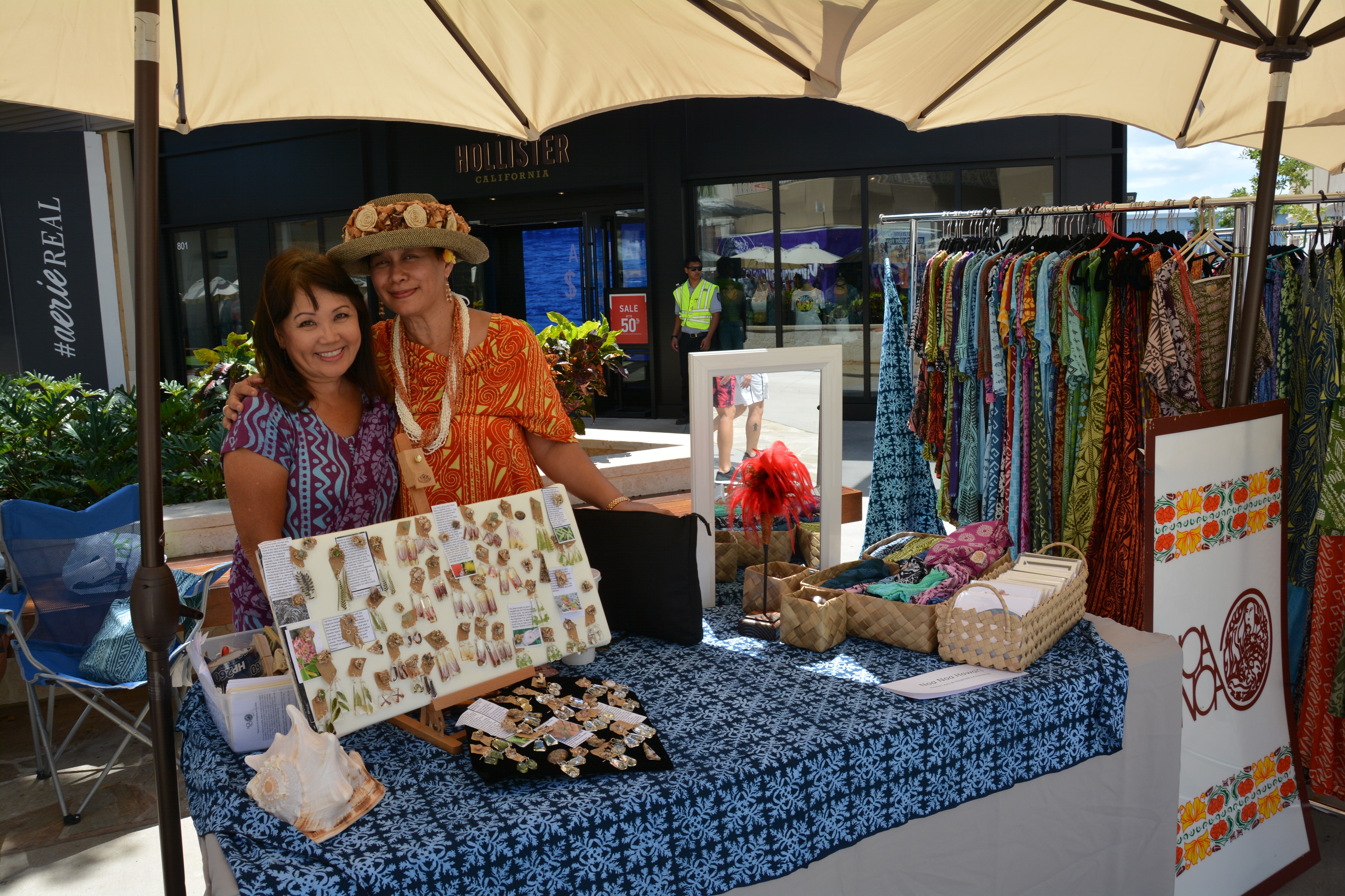 Outdoor market vendor selling colorful clothing