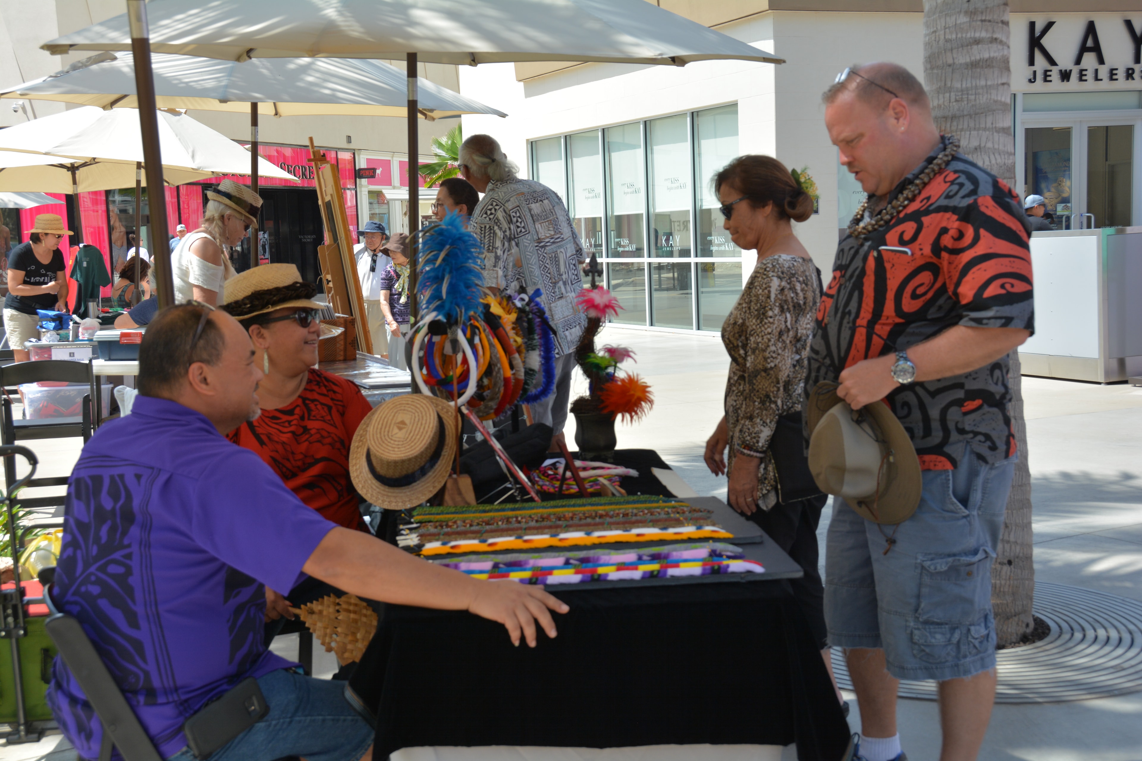 Outdoor market vendors selling colorful crafts
