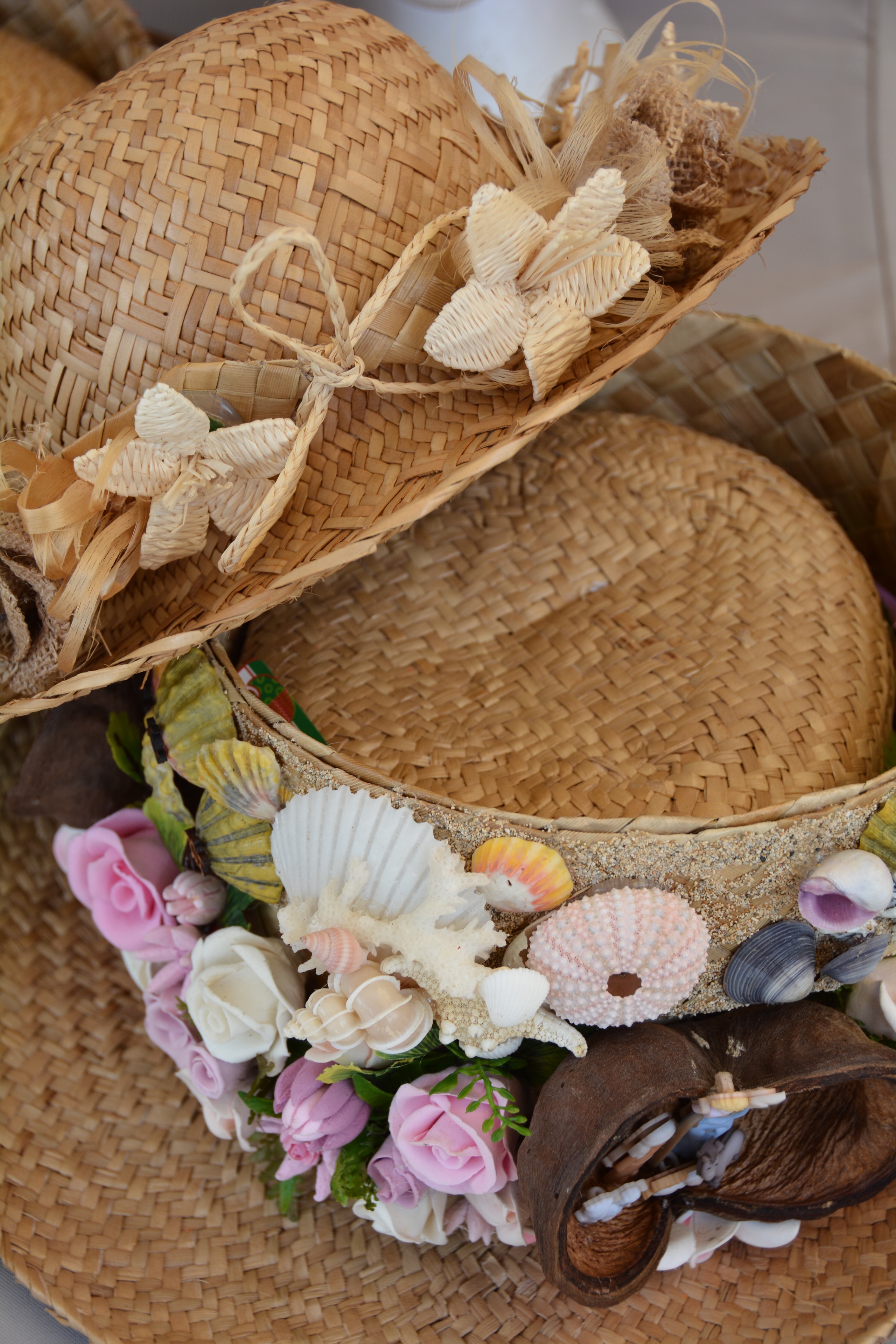 Straw hats decorated with shells and flowers