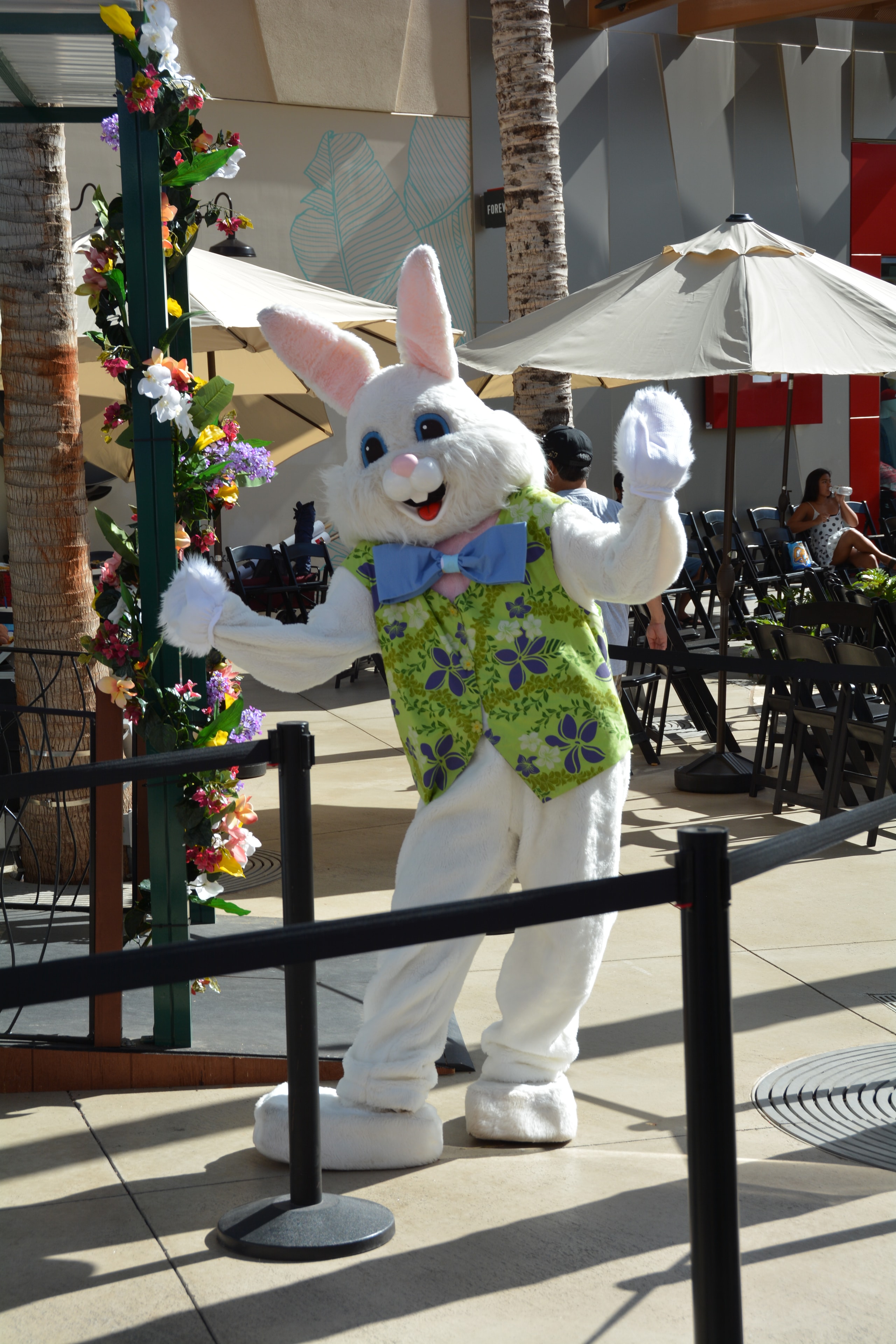 Easter bunny mascot waving outdoor patio
