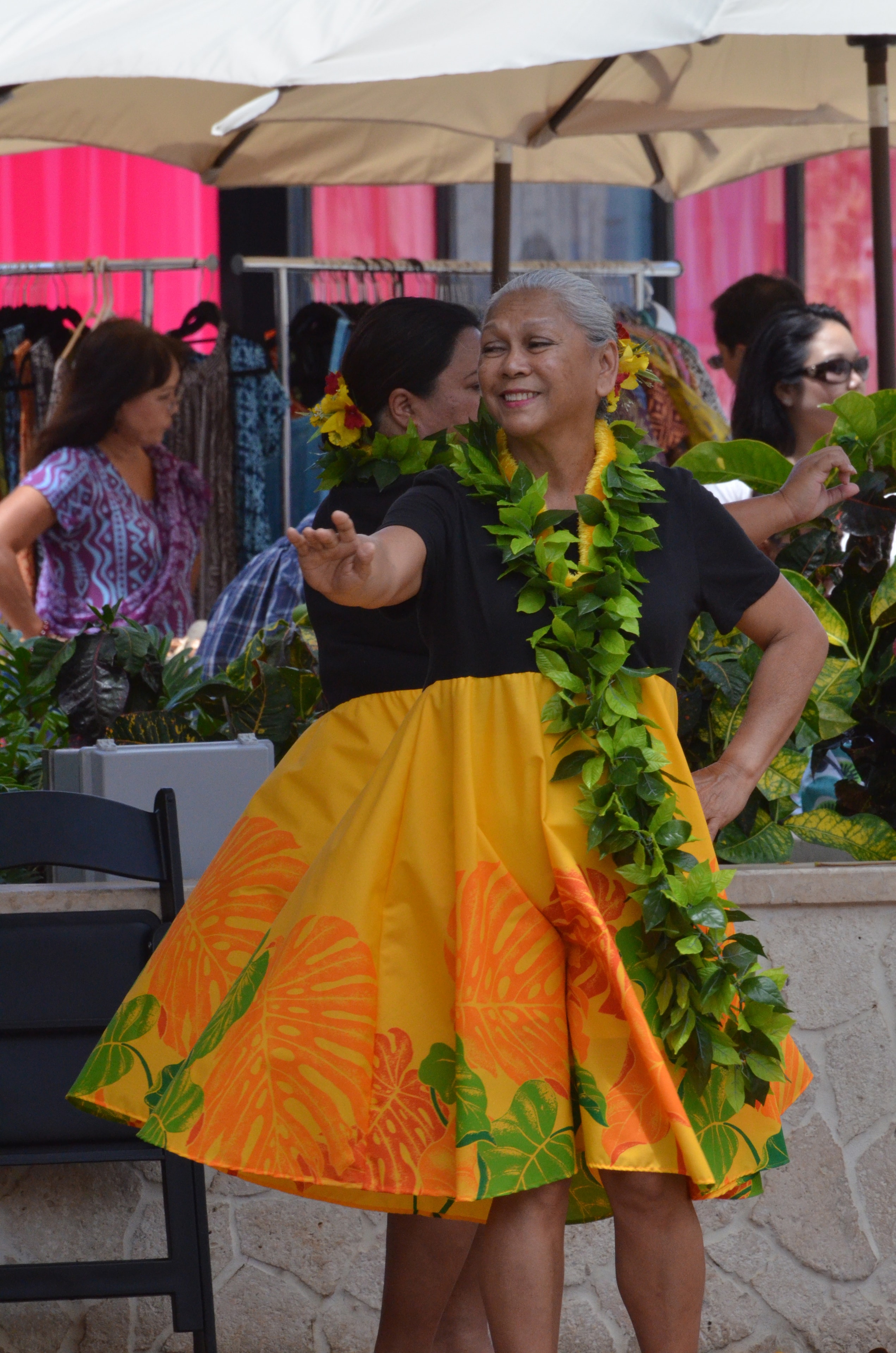 Woman wearing lei at outdoor festival event