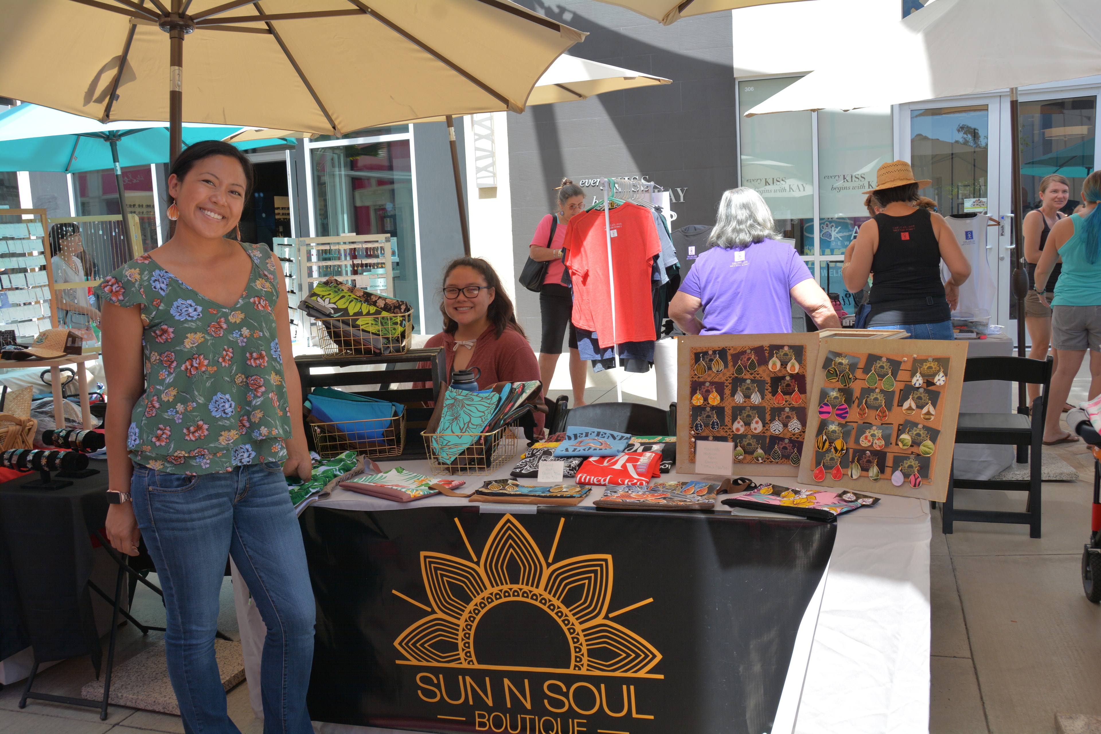 Sun N Soul Boutique vendor booth with handmade earrings and accessories