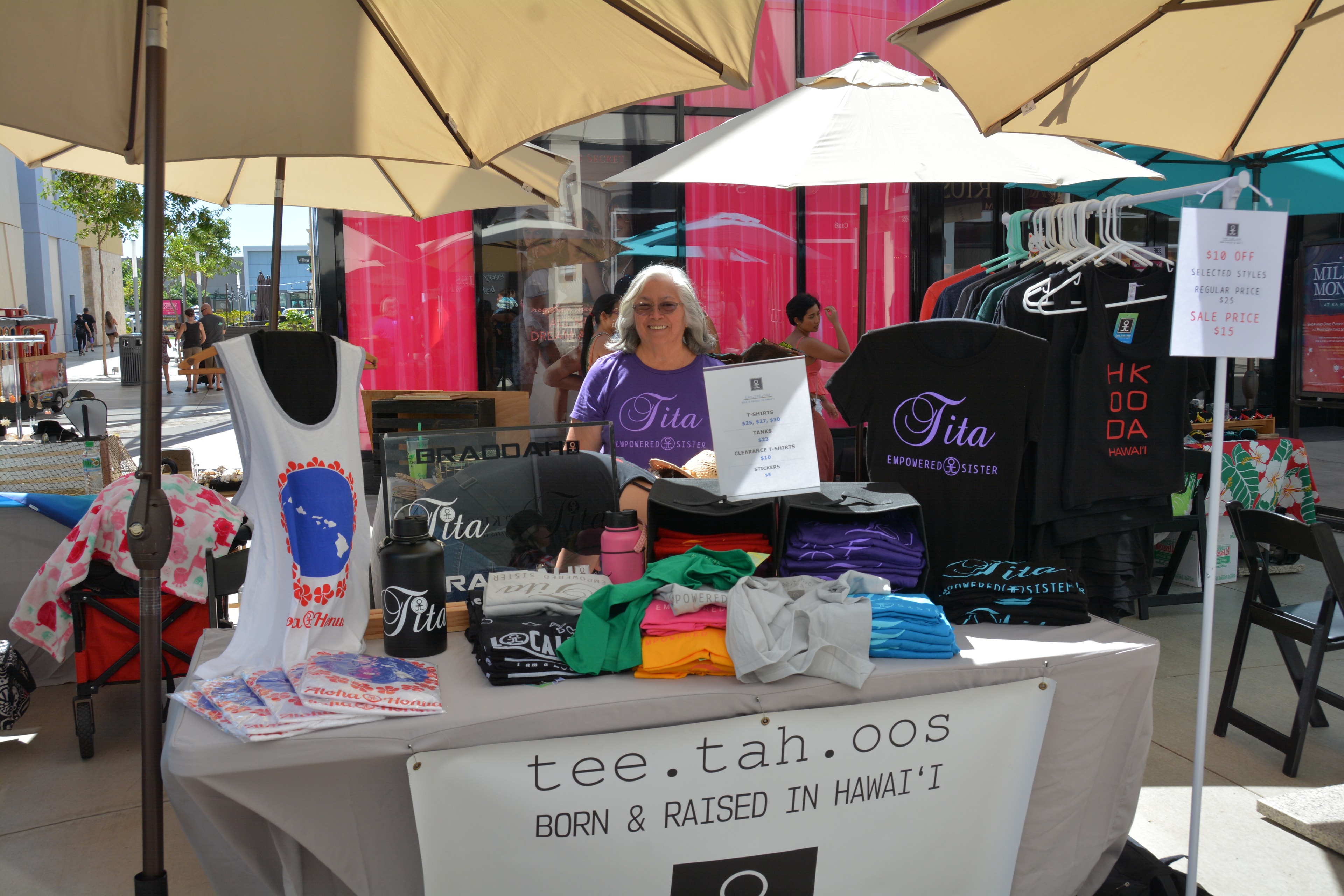 Tee.tah.oos vendor booth selling Tita Empowered Sister branded apparel at outdoor market