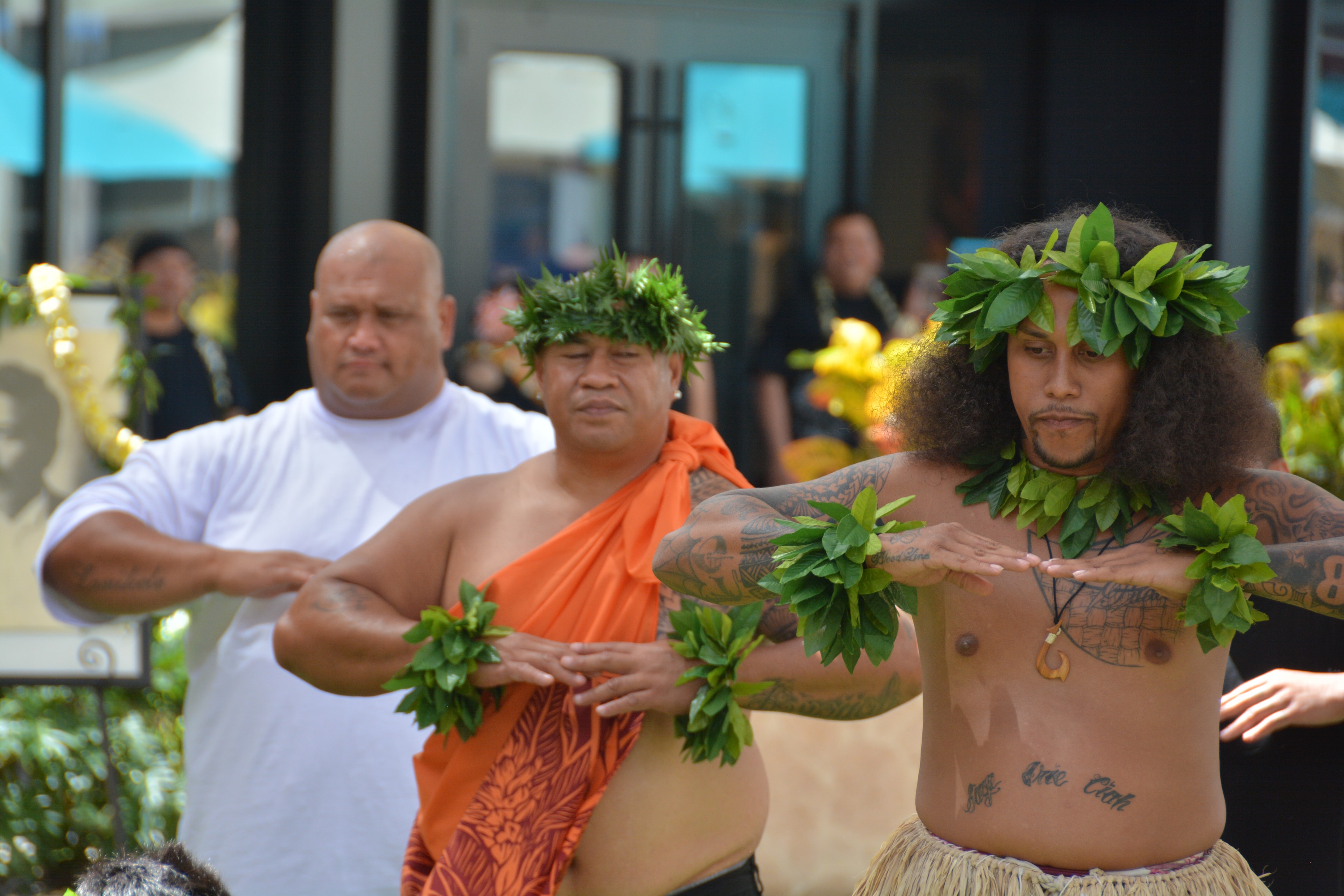 Hawaiian men performing traditional lei dance at Prince Kūhiō Day