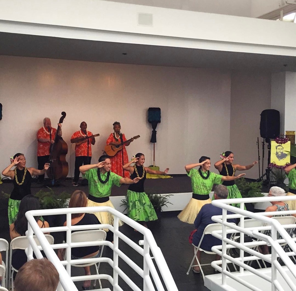 Hawaiian dancers performing with live musicians