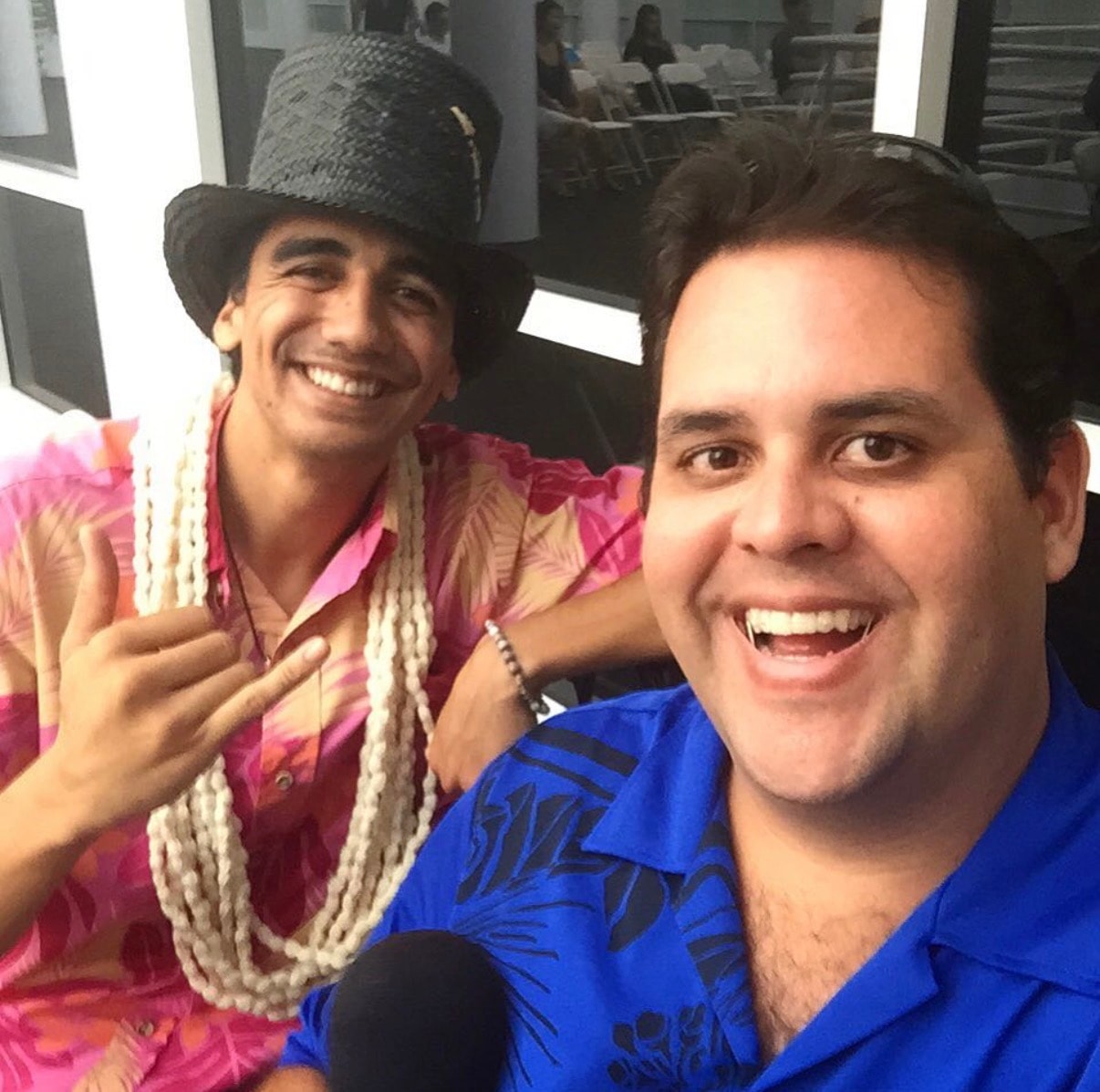 Two men in colorful western costumes smiling