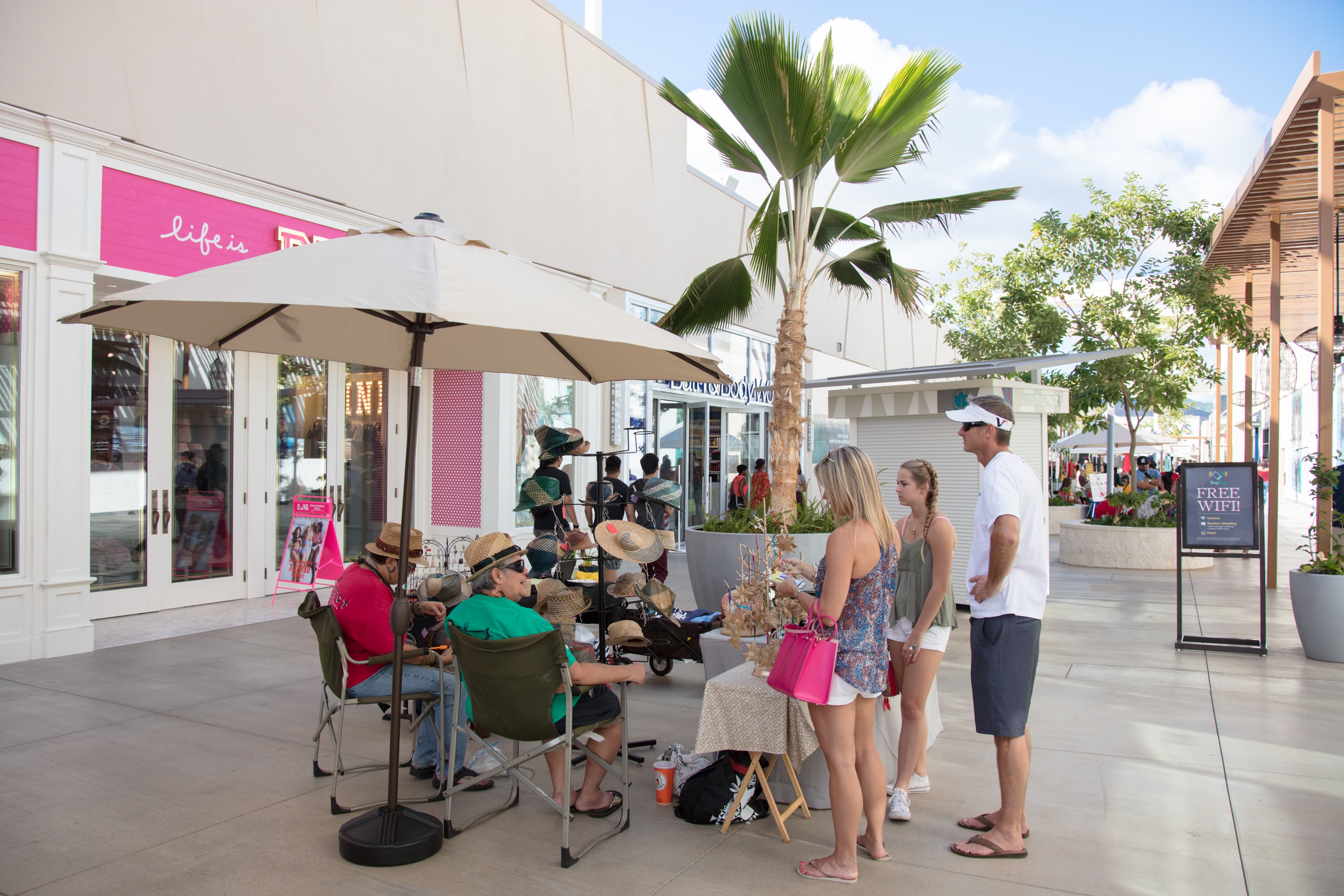 Outdoor shopping mall with palm tree