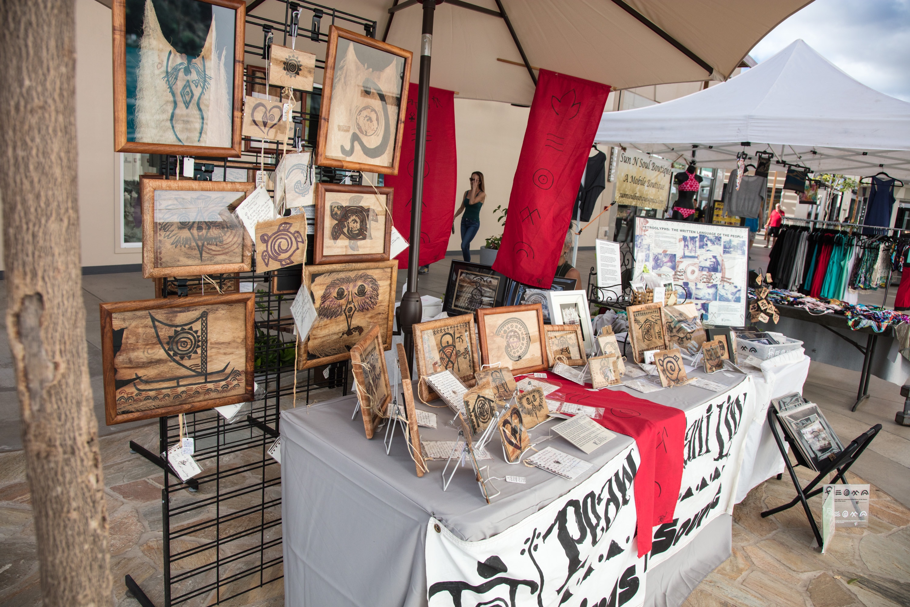 Artist booth displaying framed woodburned artwork