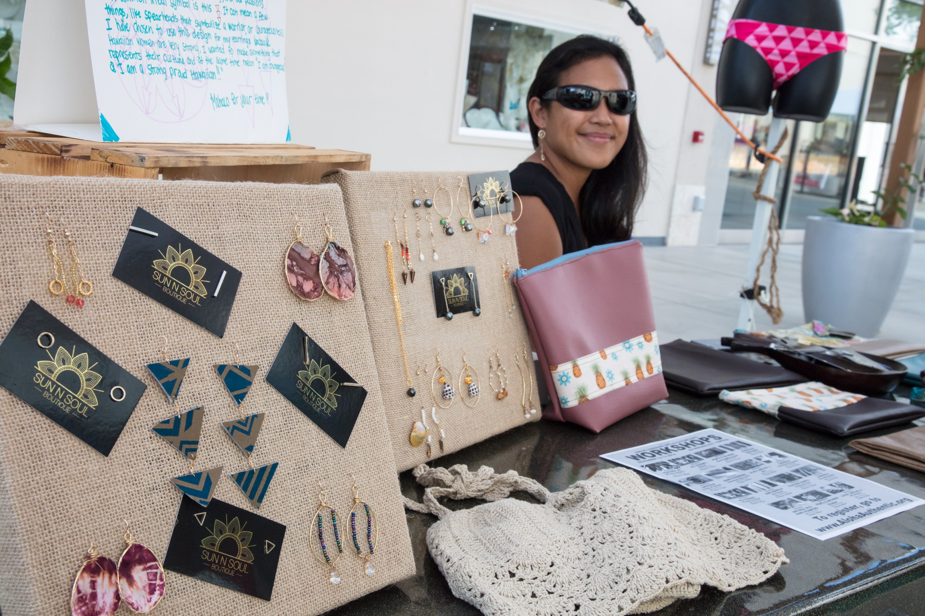 Woman selling handmade jewelry at market stall