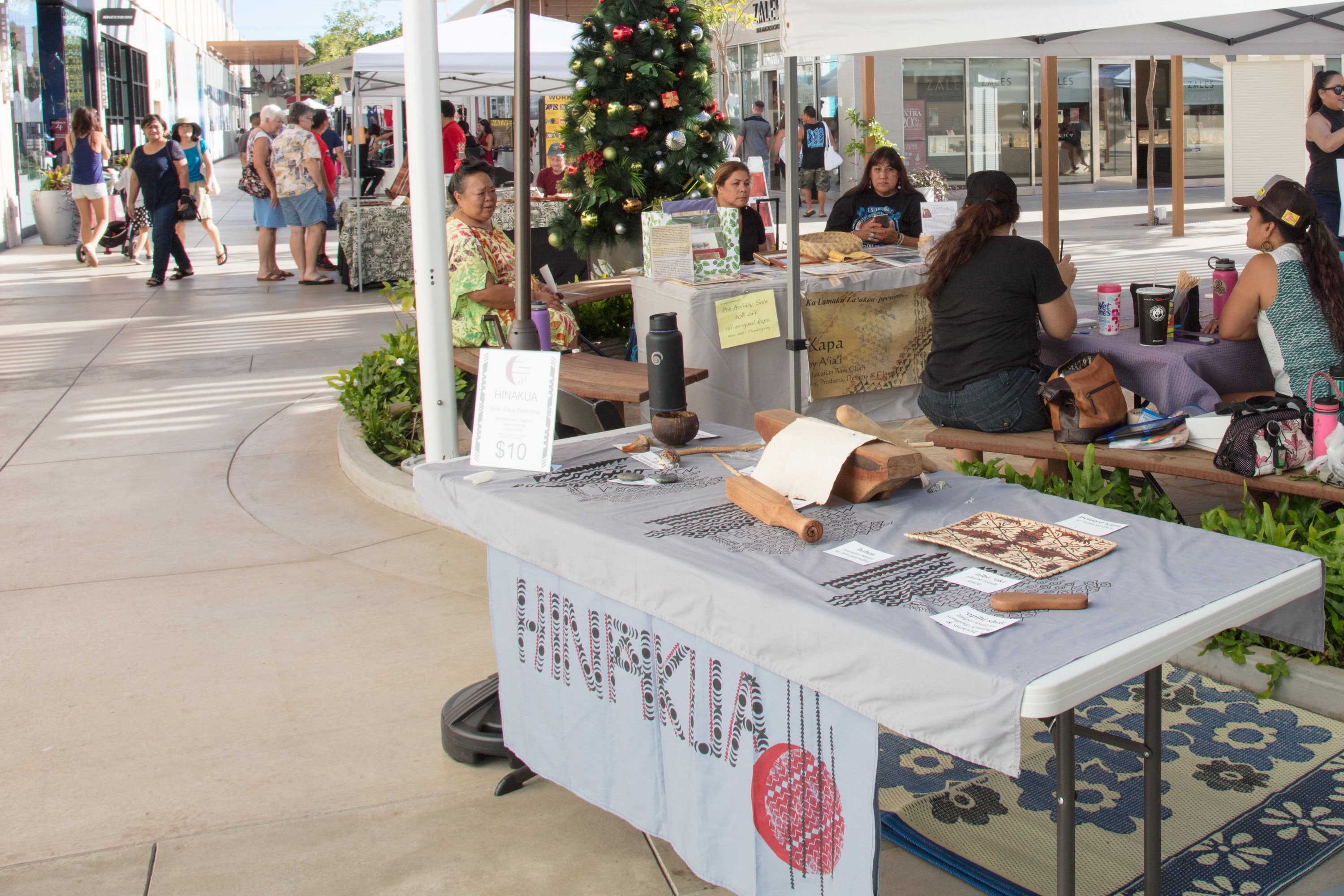 Outdoor market vendor displaying handcrafted goods