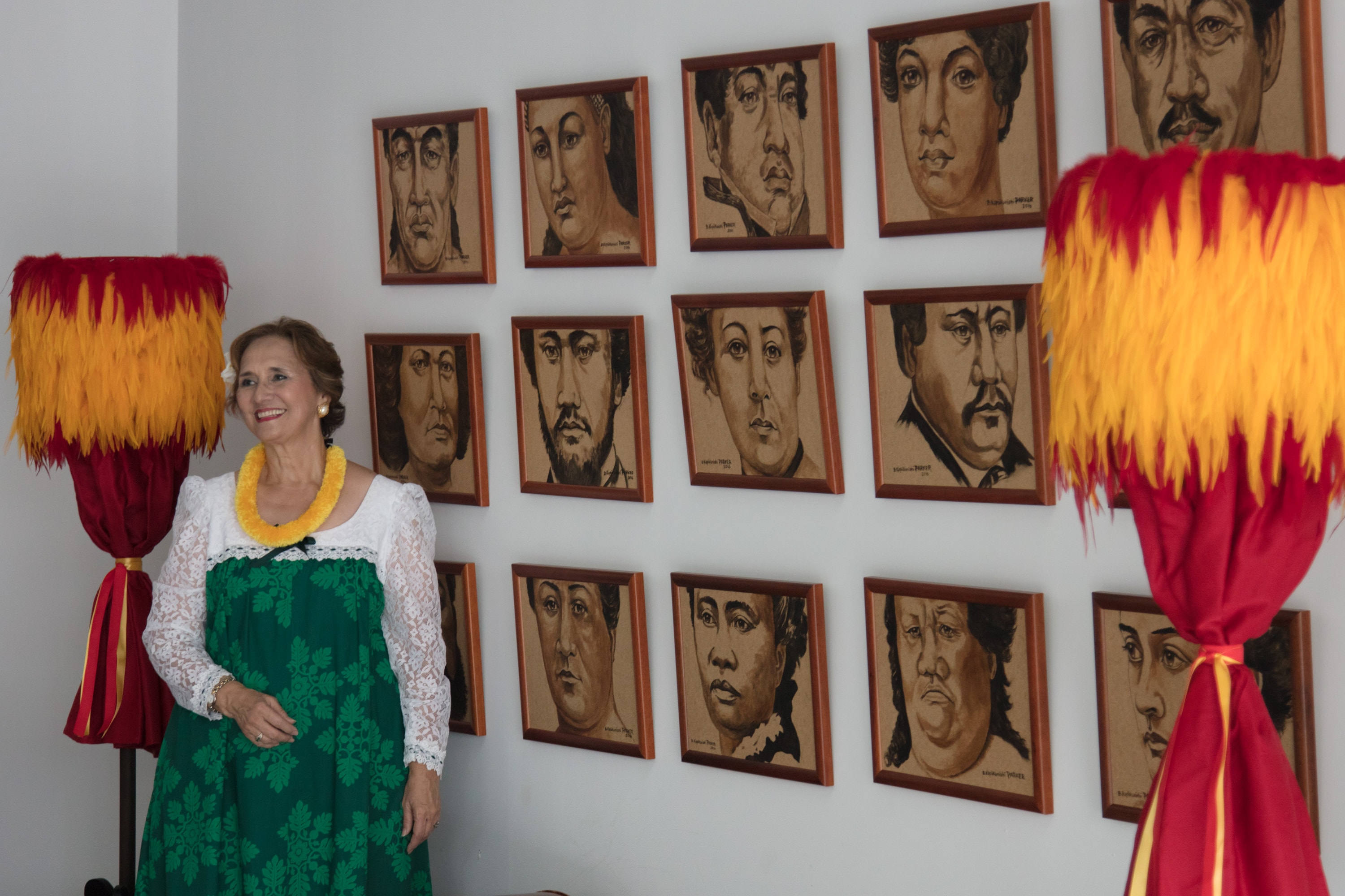 Woman in traditional dress with portrait gallery