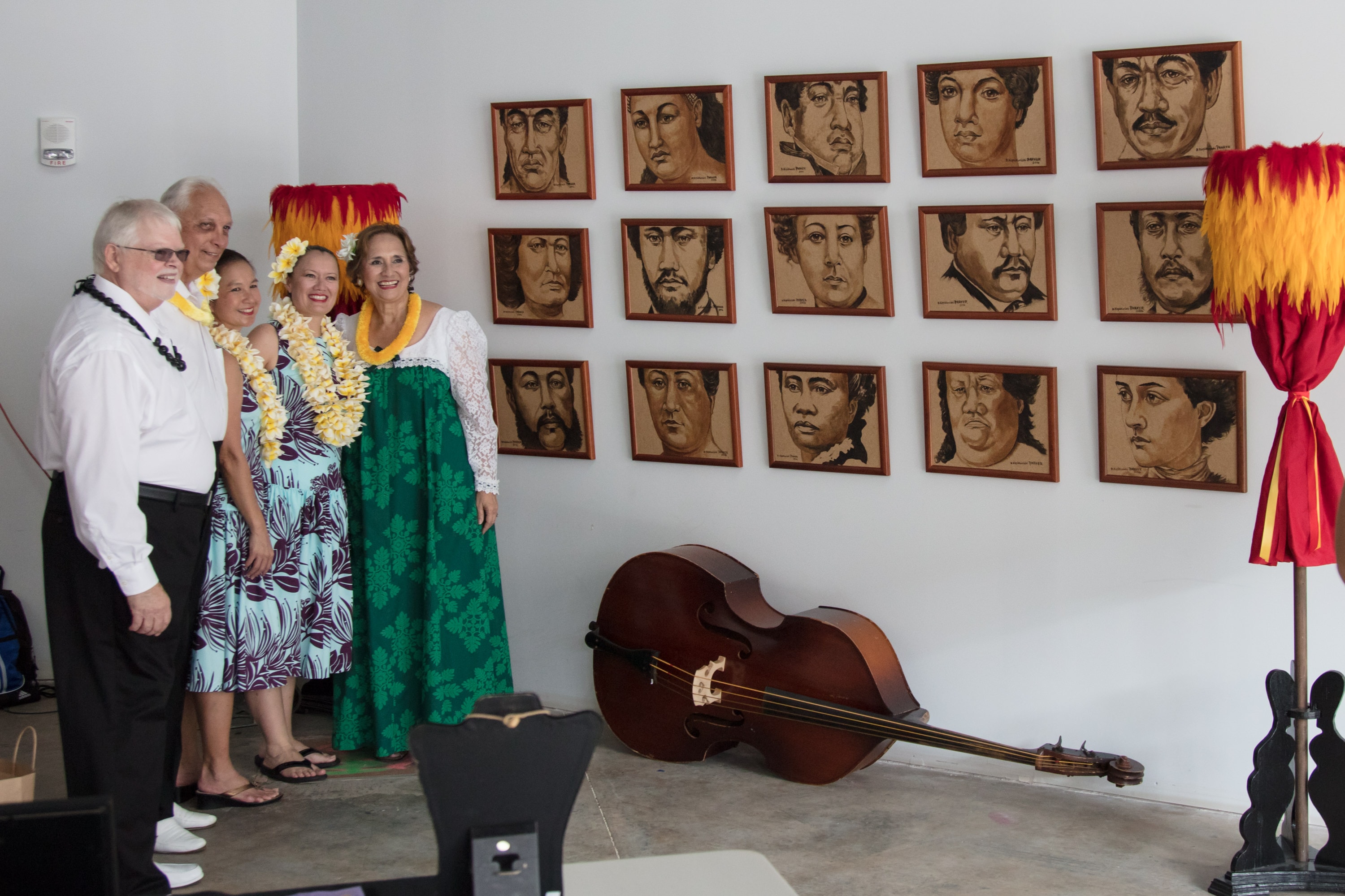 People wearing lei viewing portrait gallery