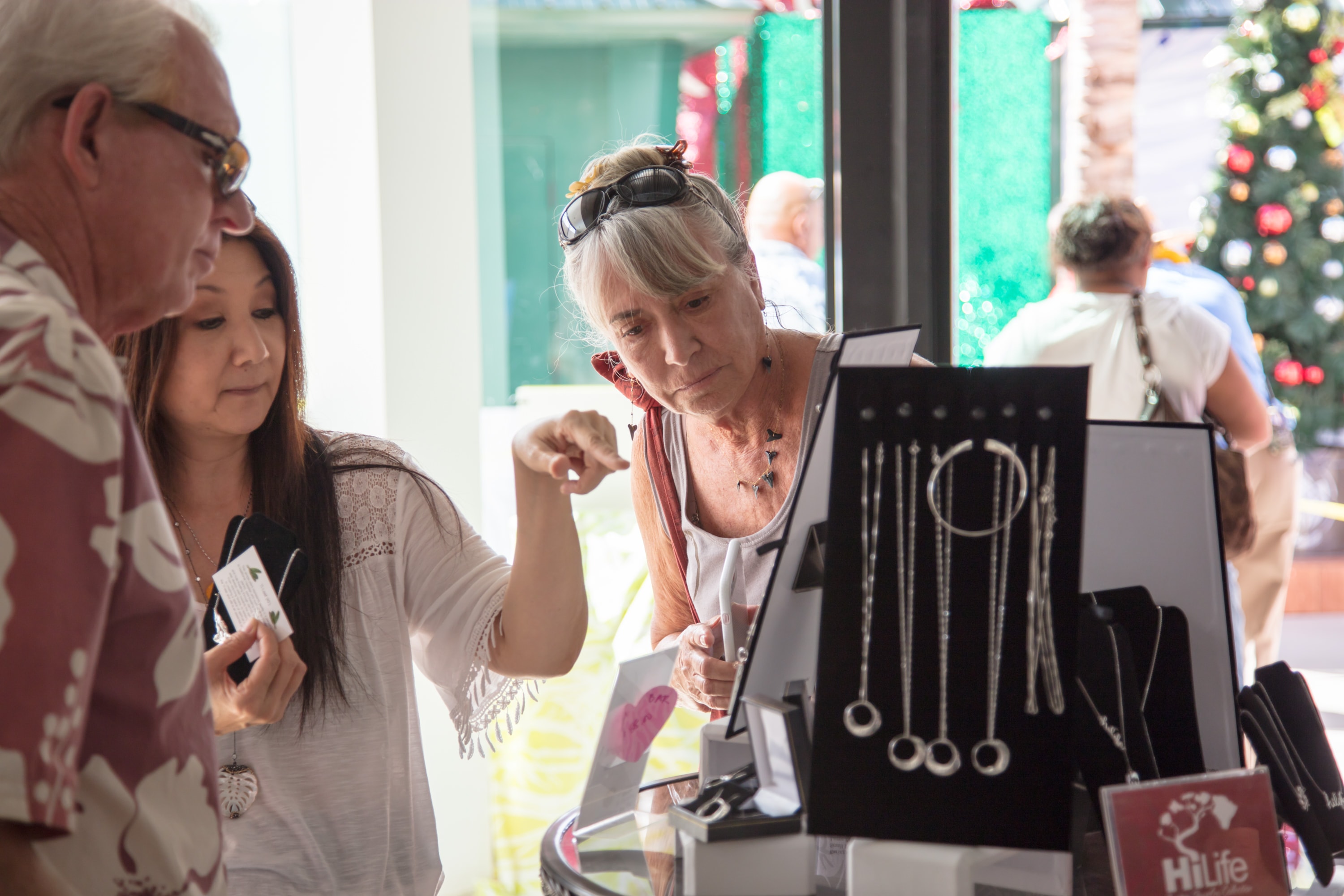 Shoppers browsing jewelry at holiday market