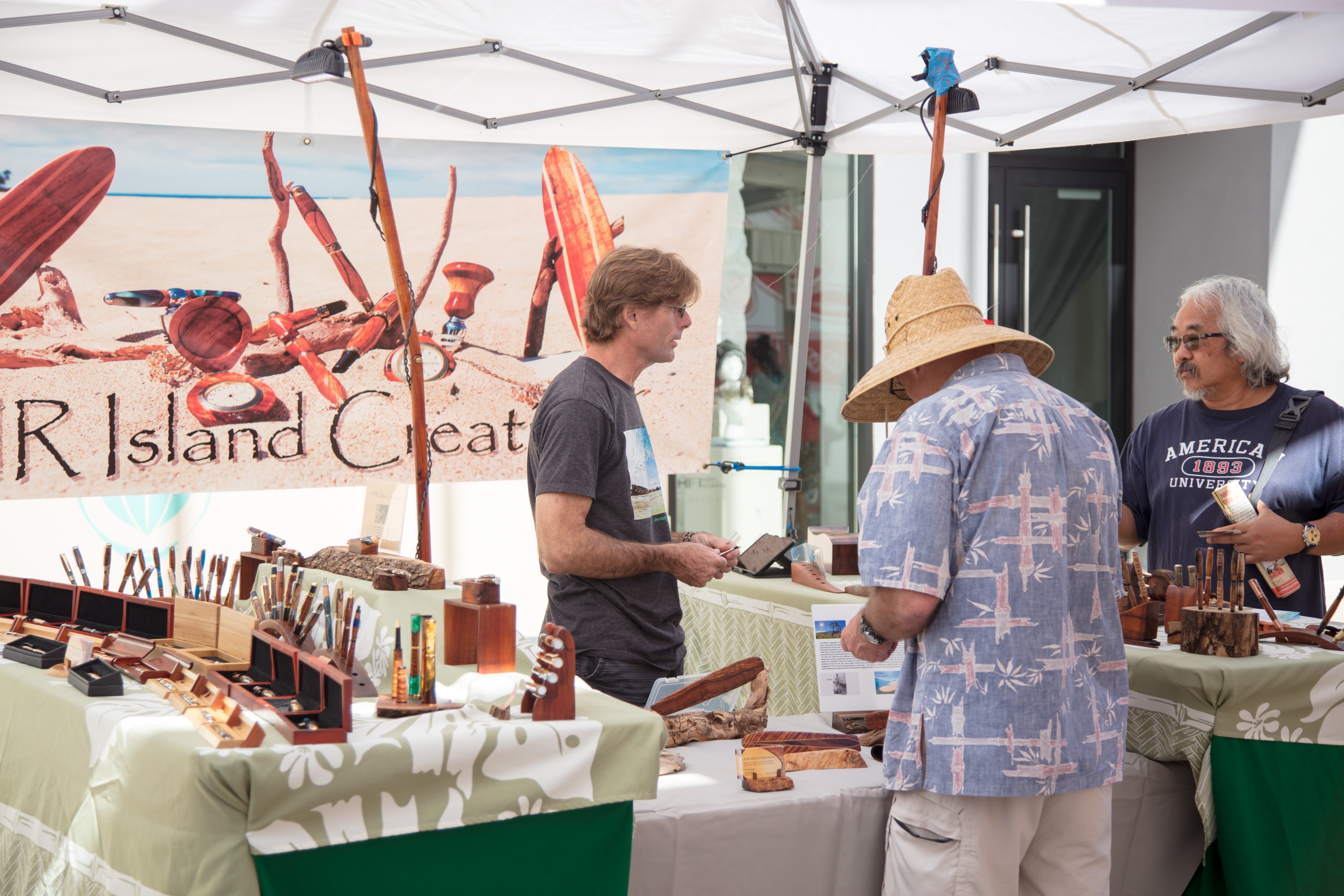 Artisans selling wooden crafts at market booth