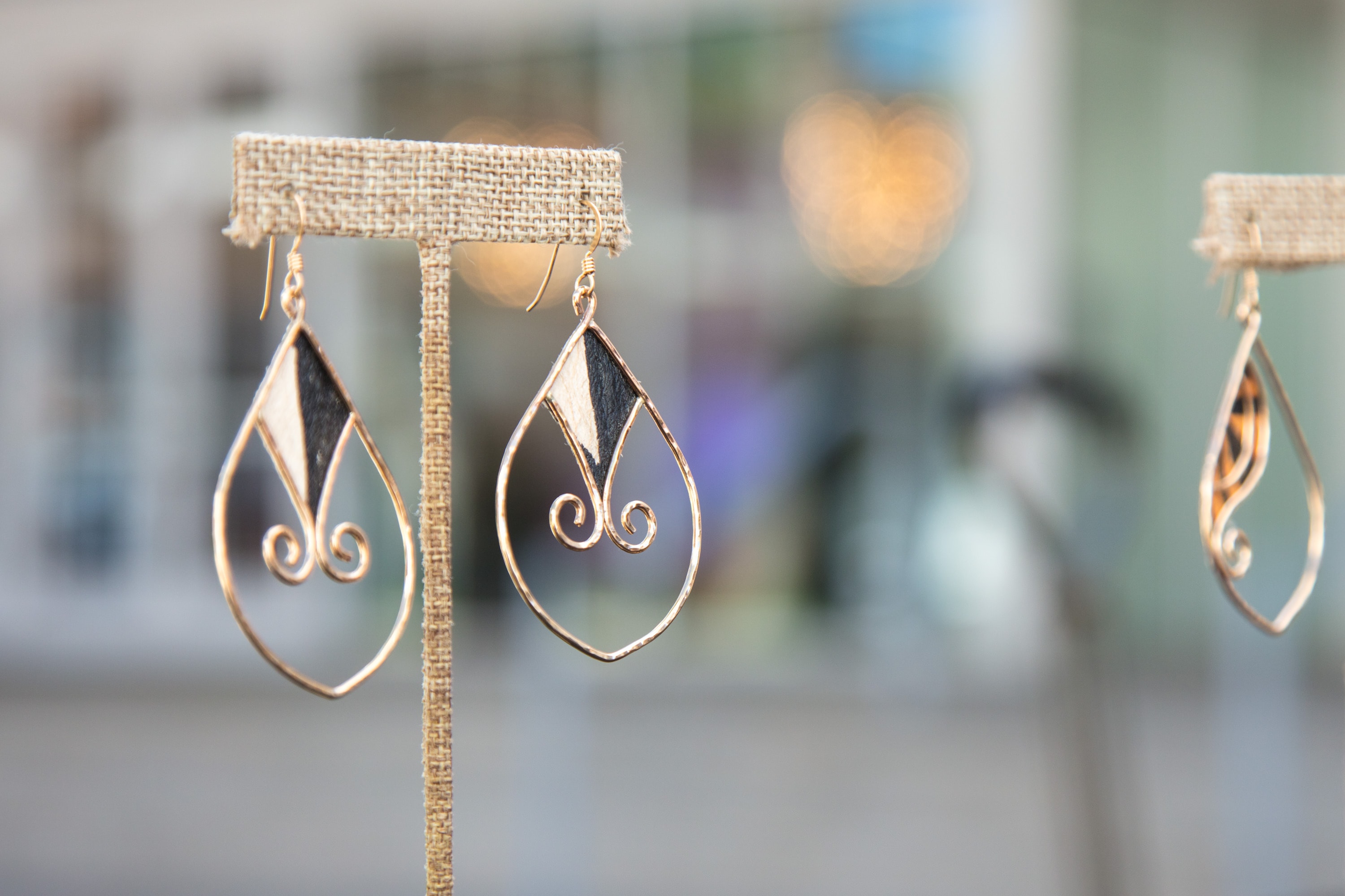Gold teardrop earrings with black stone inlay