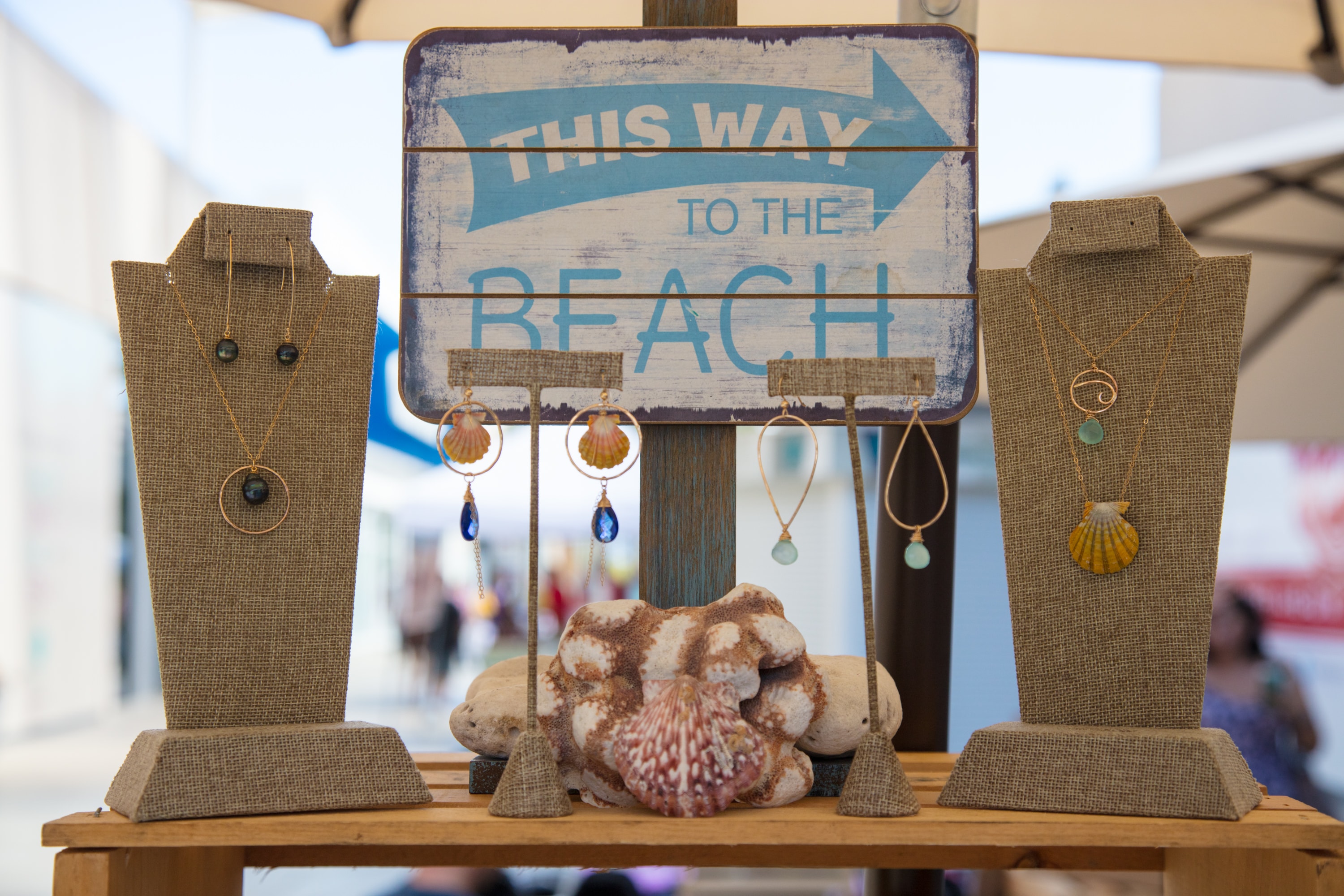 Beach jewelry display with directional sign