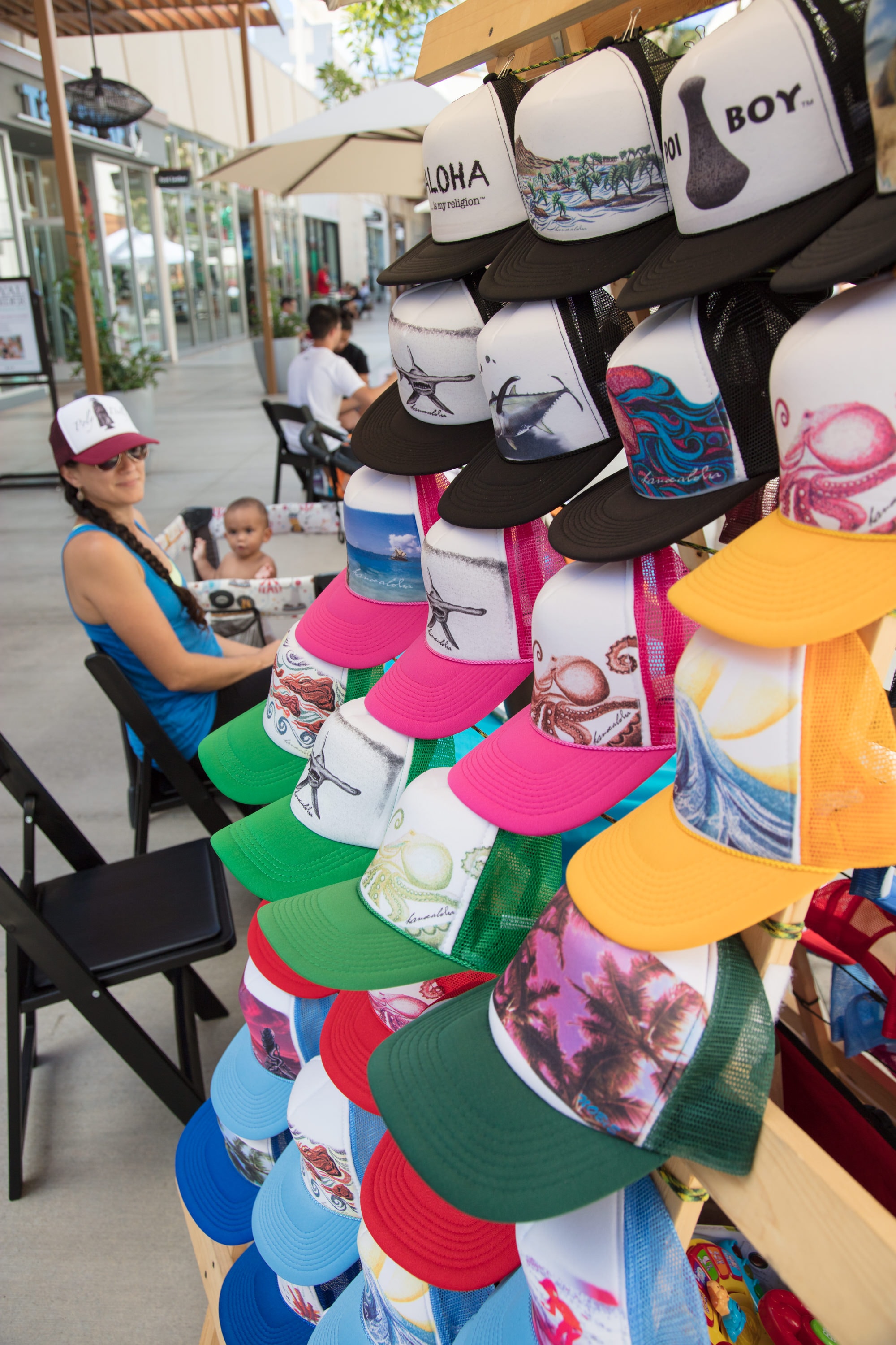 Colorful graphic baseball caps outdoor market display