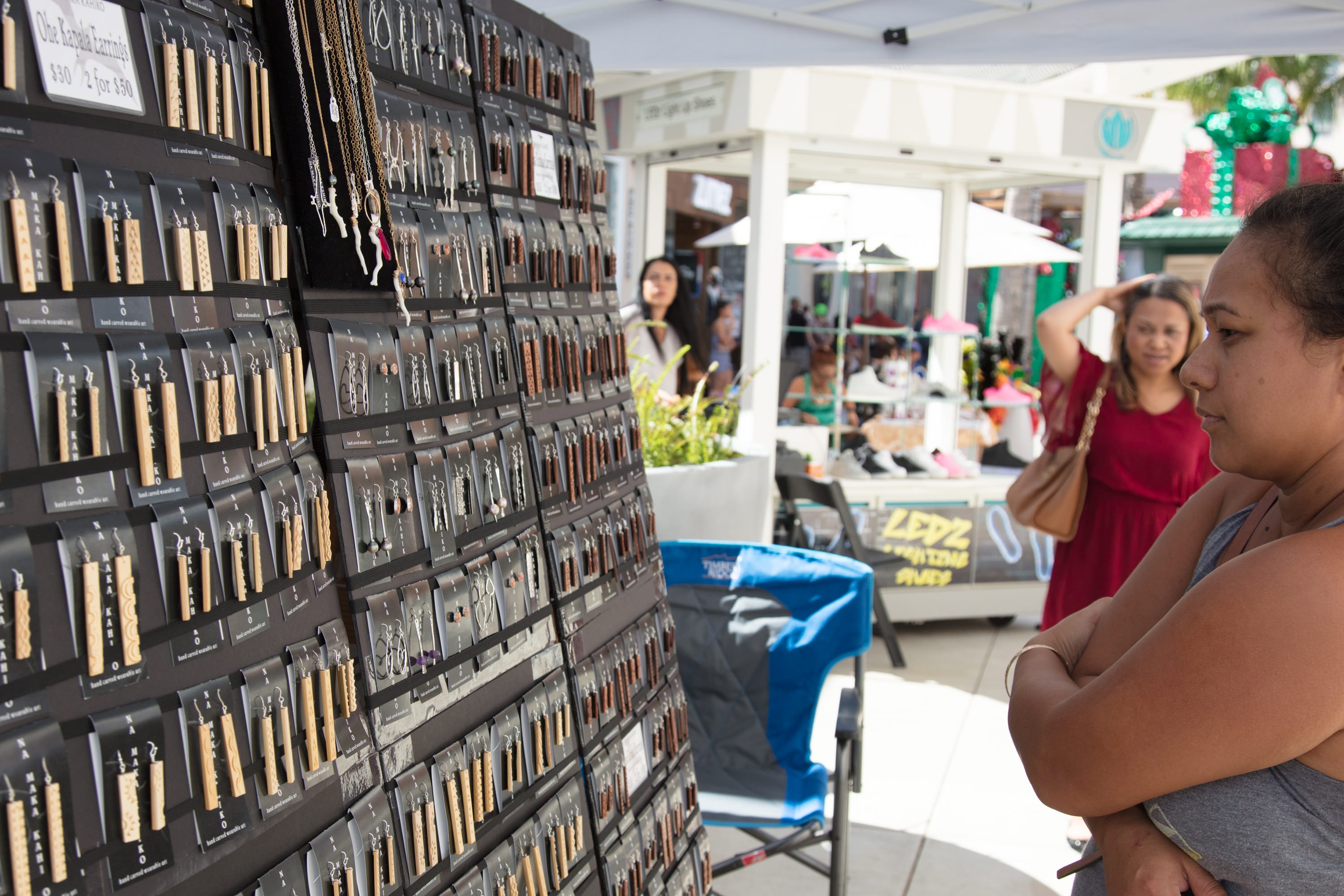 Woman browsing jewelry display at market