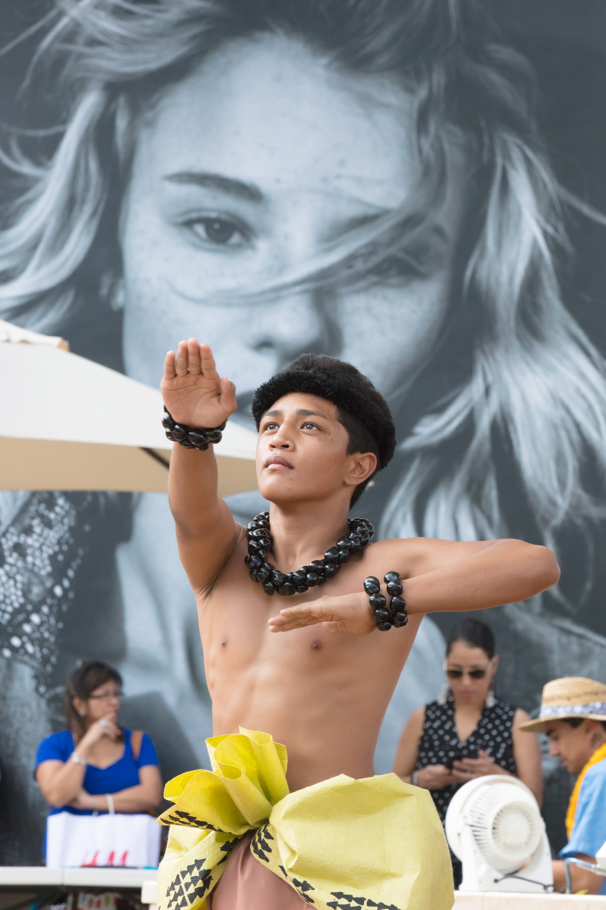 Young performer posing street mural backdrop