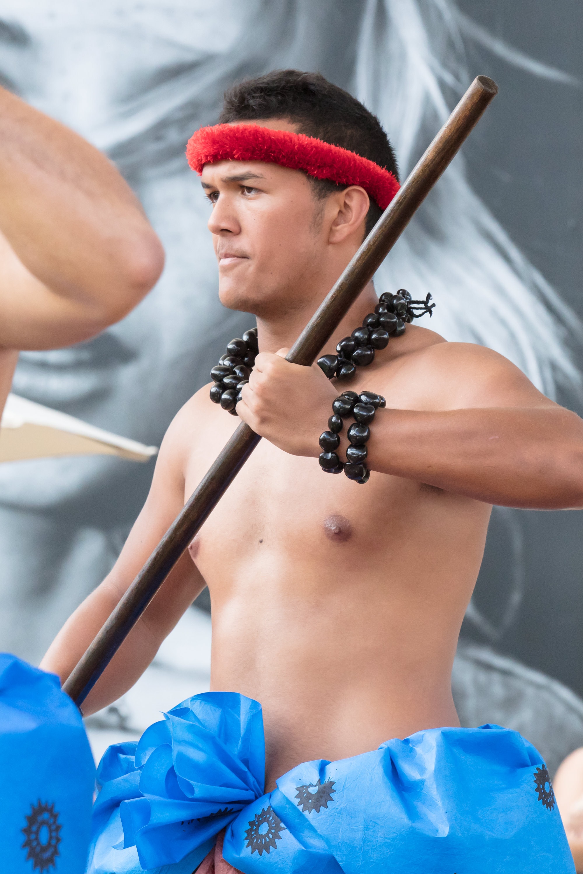 Man in tribal costume holding wooden staff