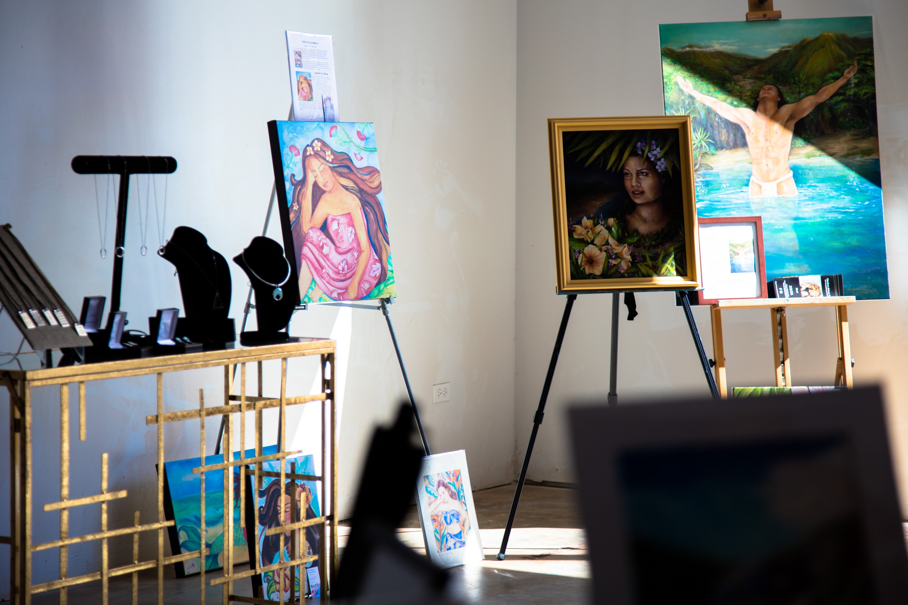 Art gallery exhibition with colorful paintings display