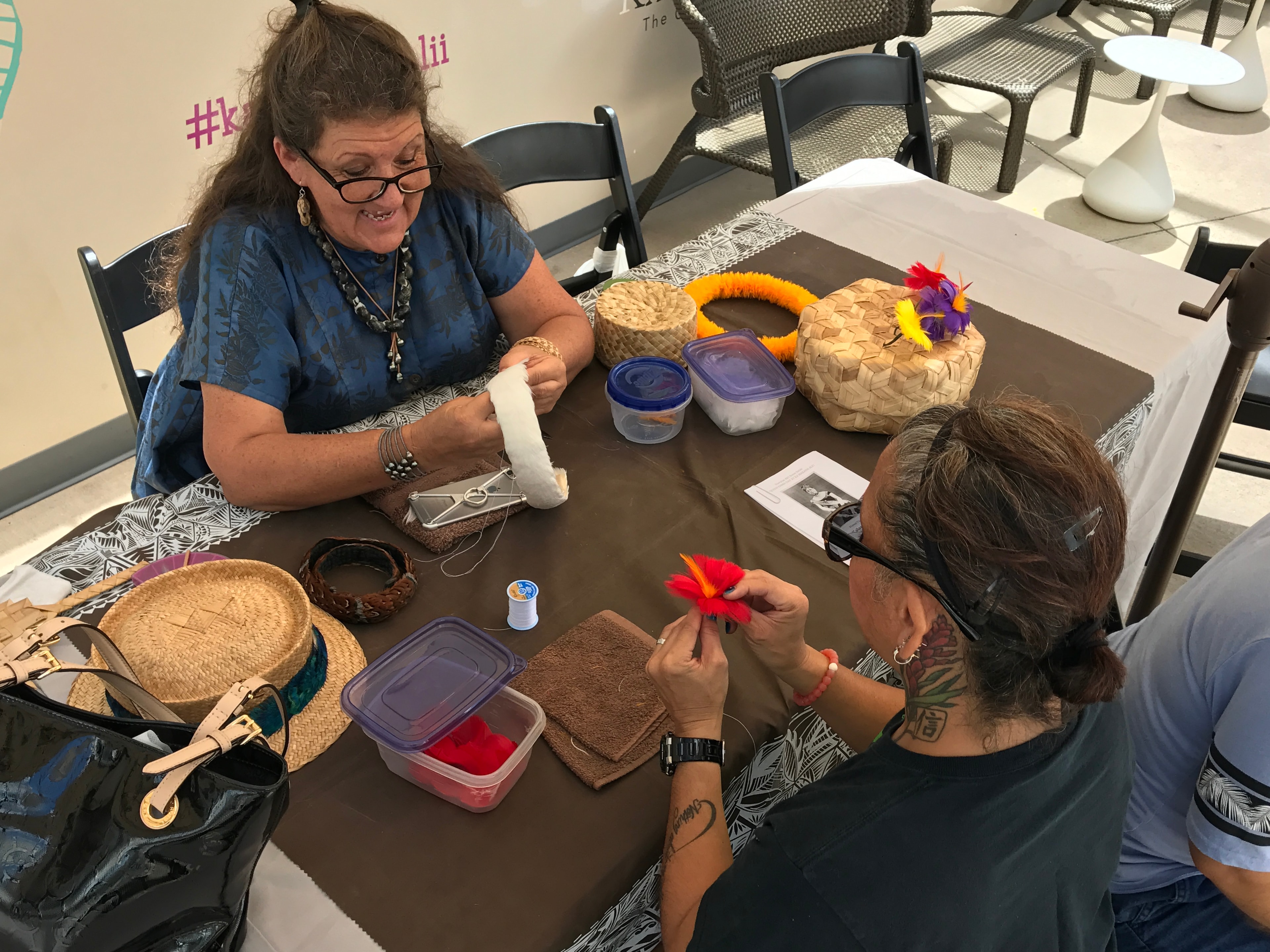 Women crafting colorful decorative flowers together