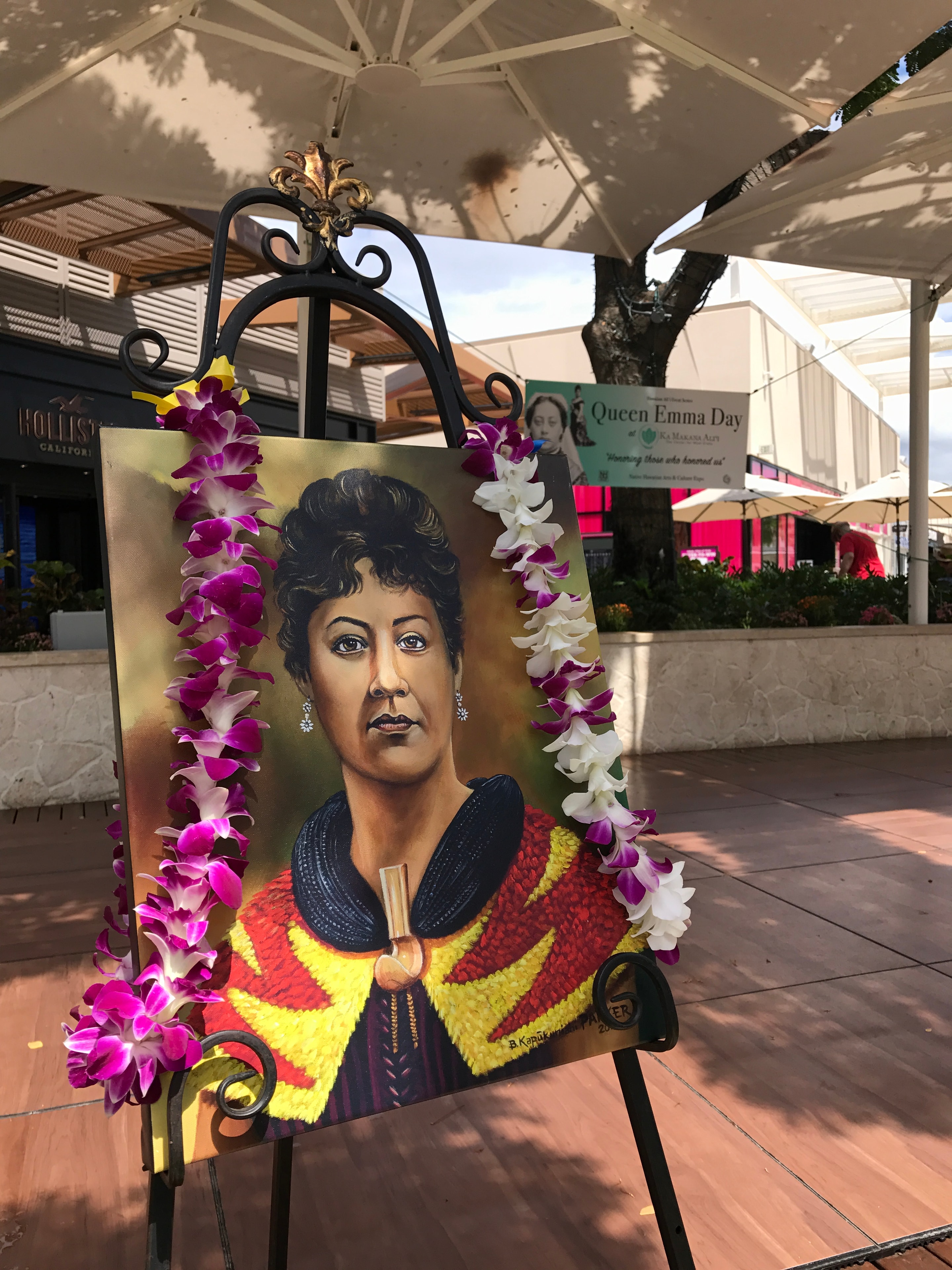Portrait painting decorated with orchid lei