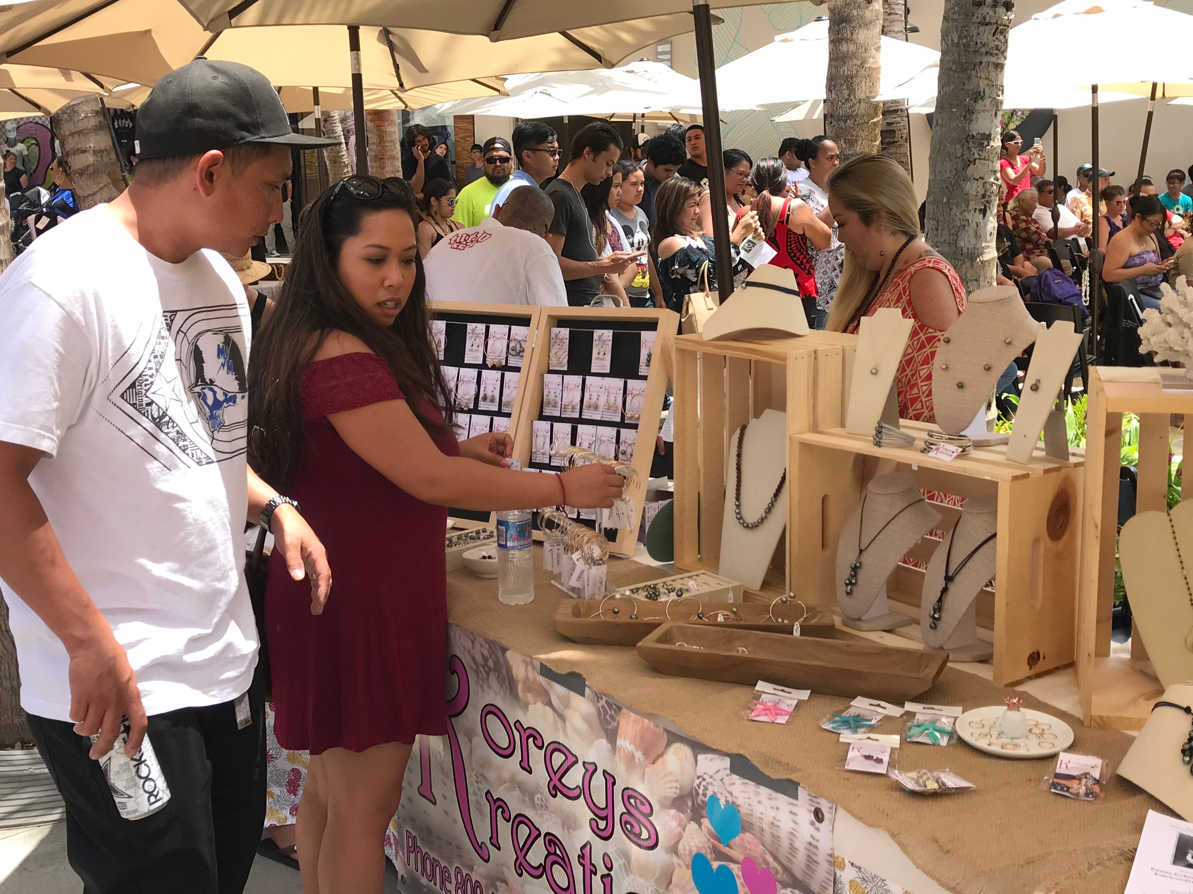 Outdoor market vendor selling handmade jewelry