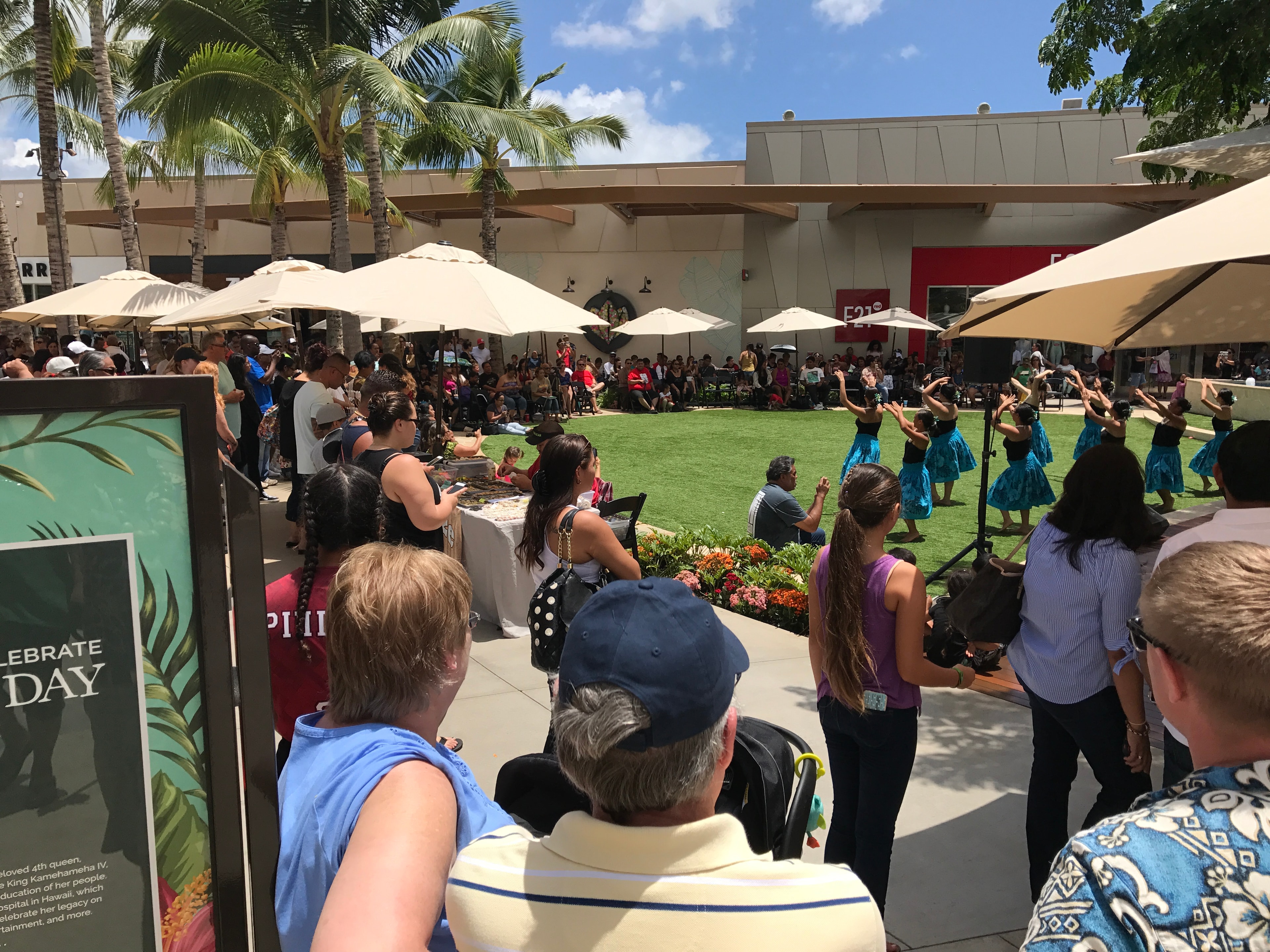 Outdoor community celebration with hula dancers